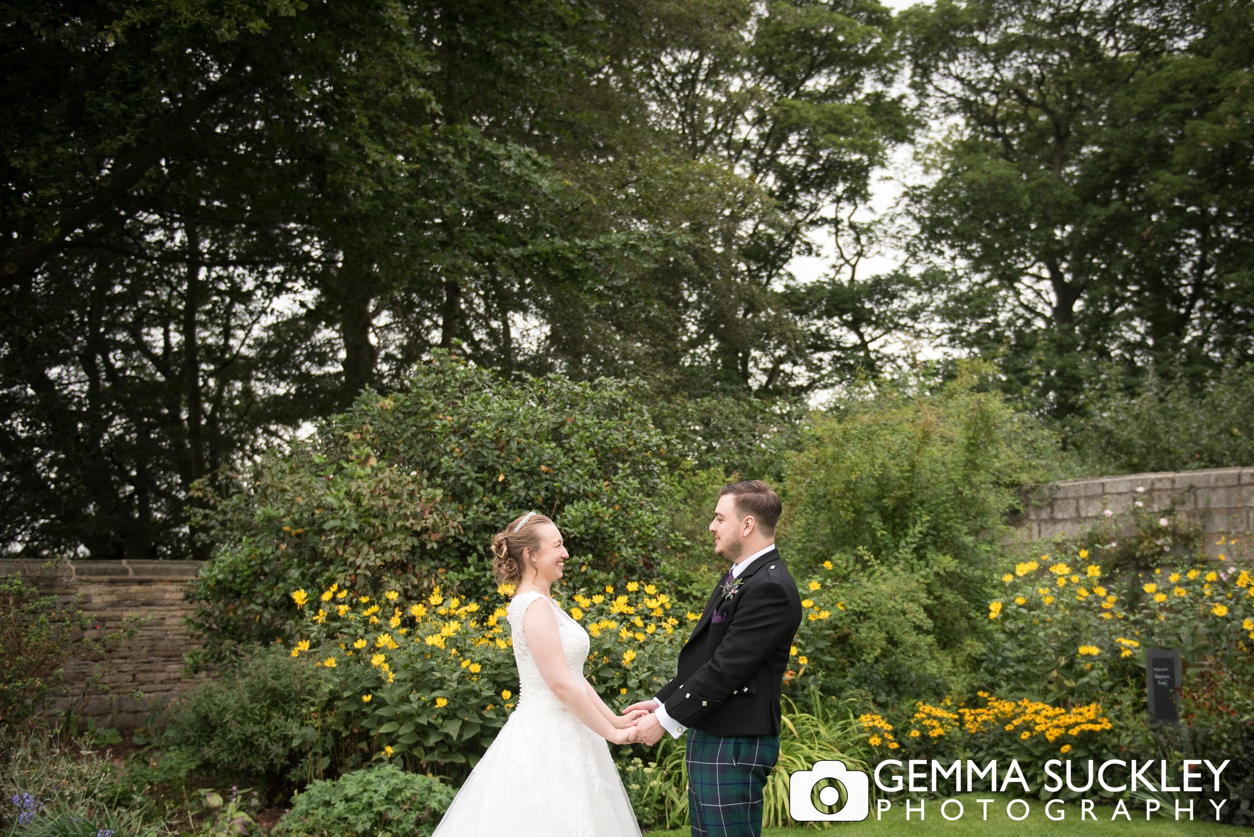 bride and groom in the flower garden at east riddlesden hall