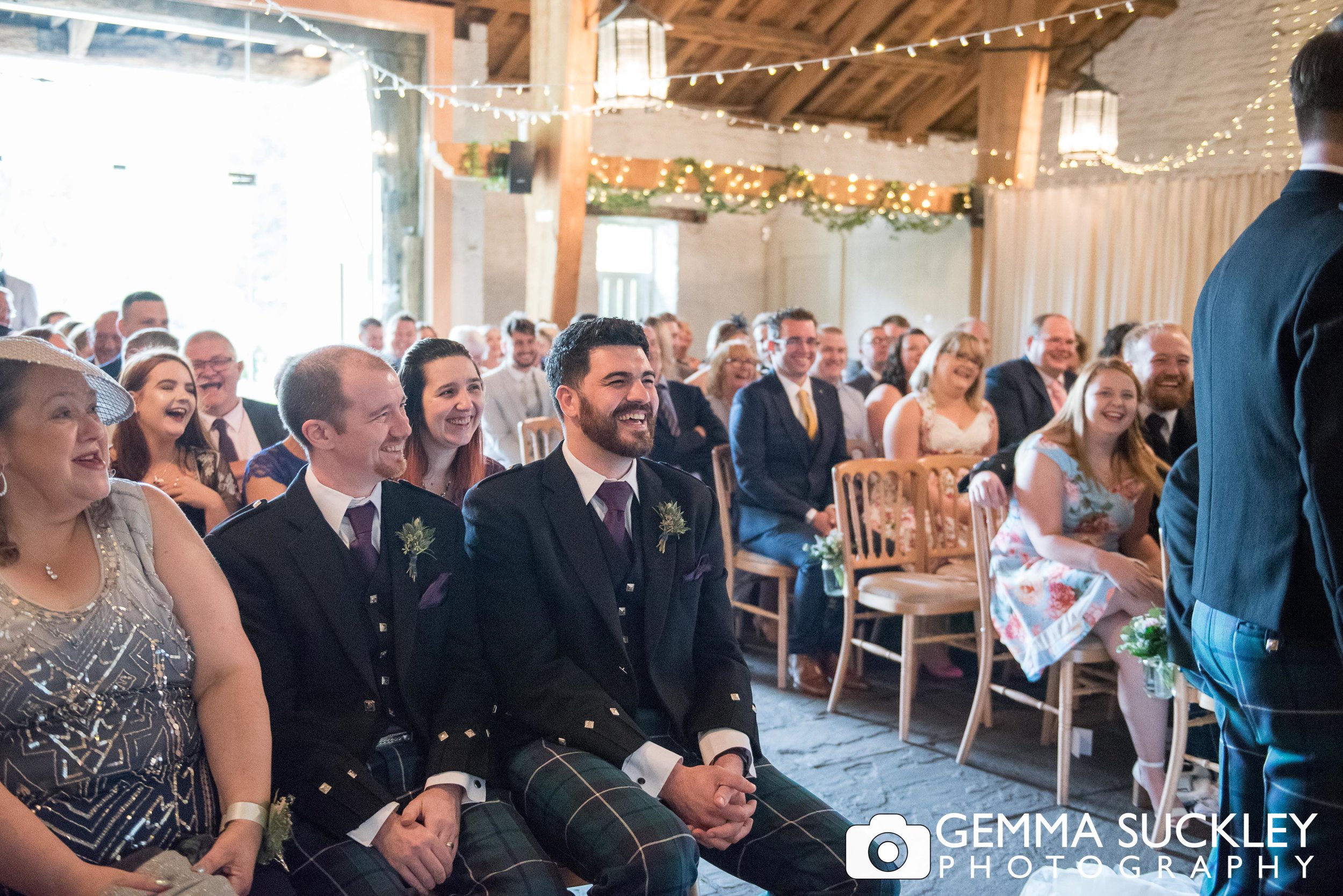 wedding guests laughing at east riddlesden hall