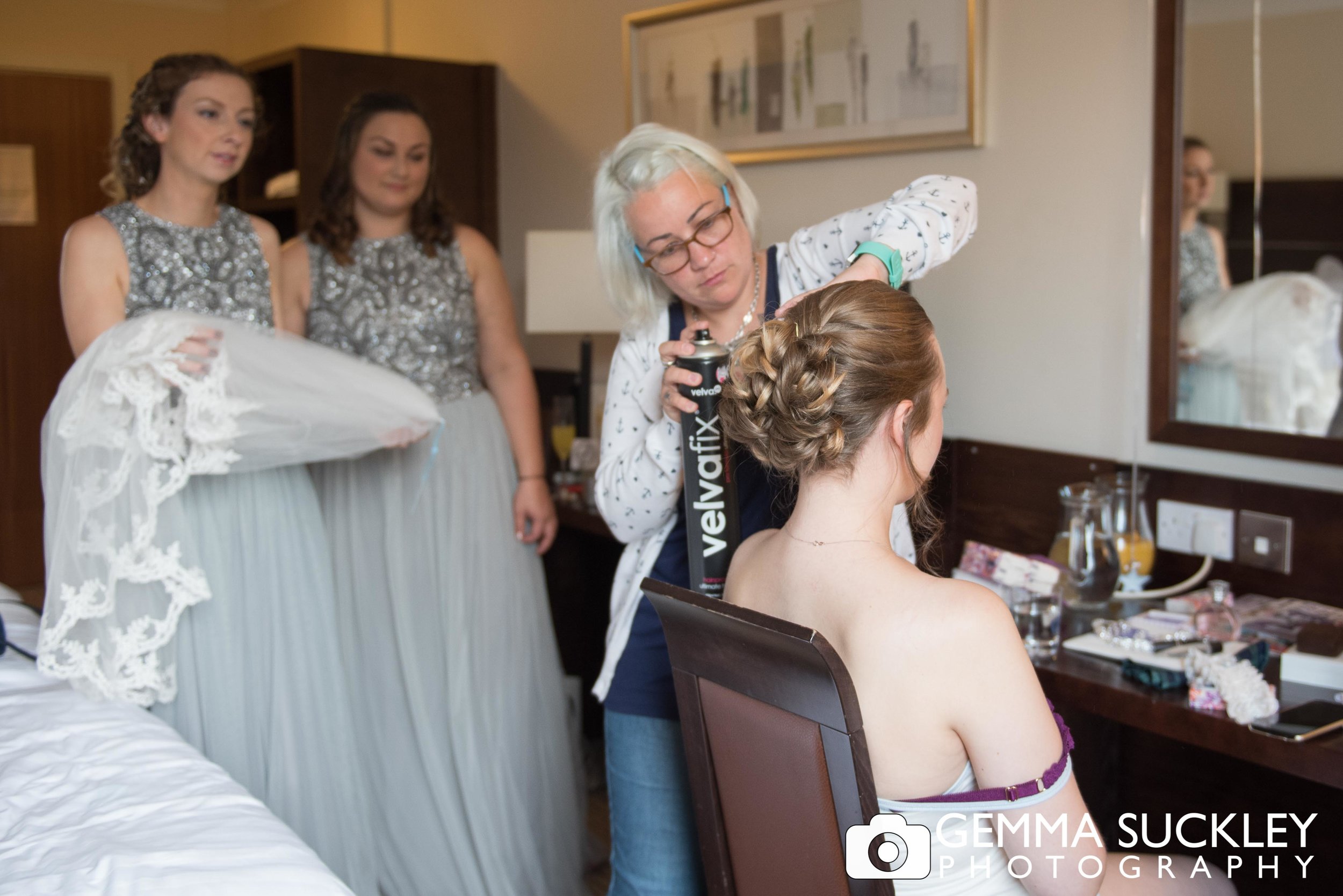 bride having her hair put up at mercure hotel