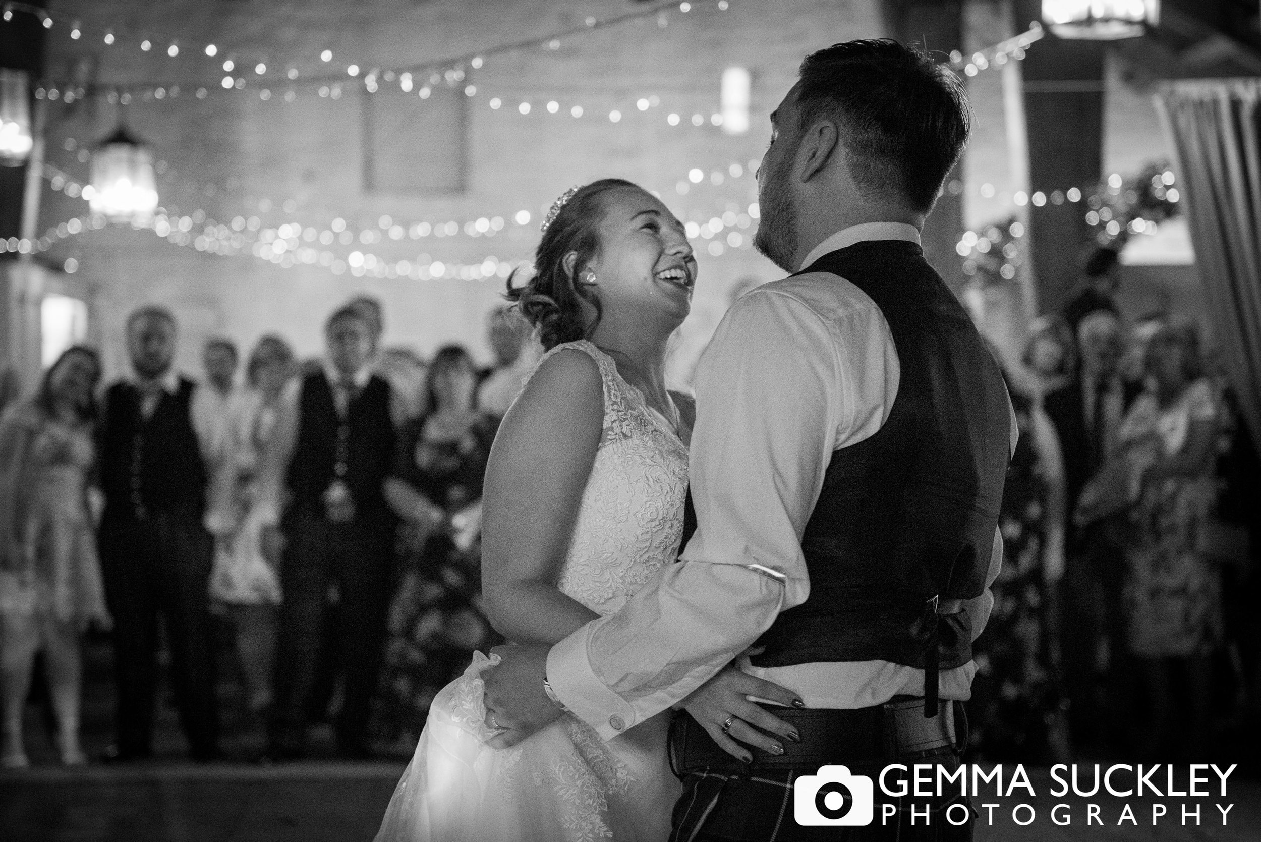 black and white photo of bride and groom dancing at east riddlsden hall