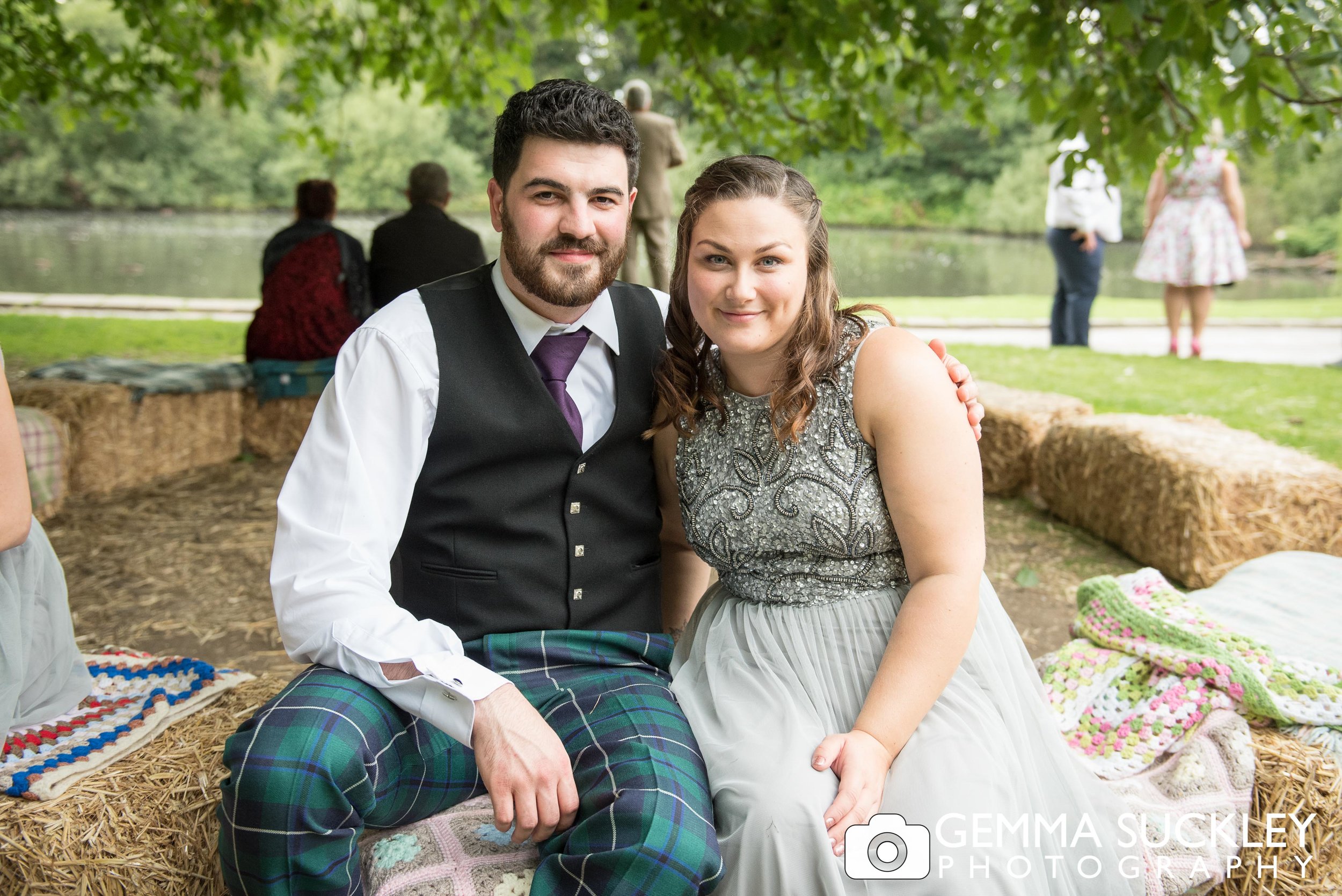 couple sat on the hay bails at east riddlsden hall