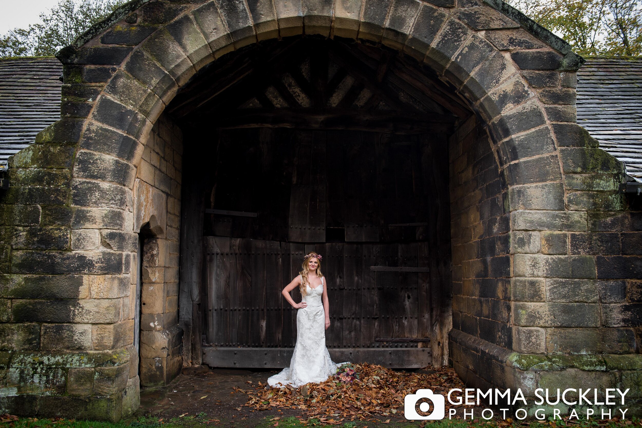 a bride in the barn doorway at east riddlesden hall