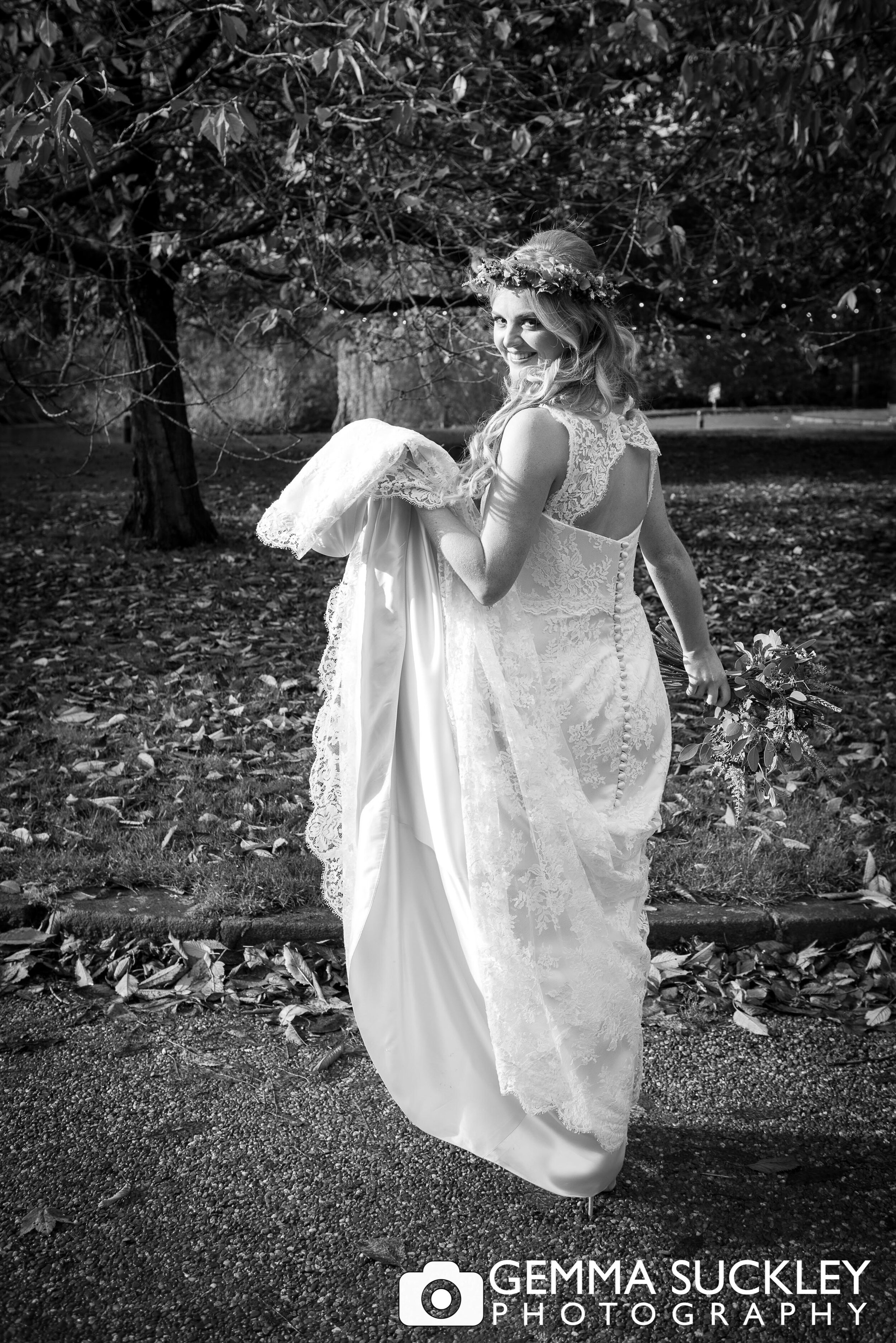 a bride walking through the ground at east riddlesden hall