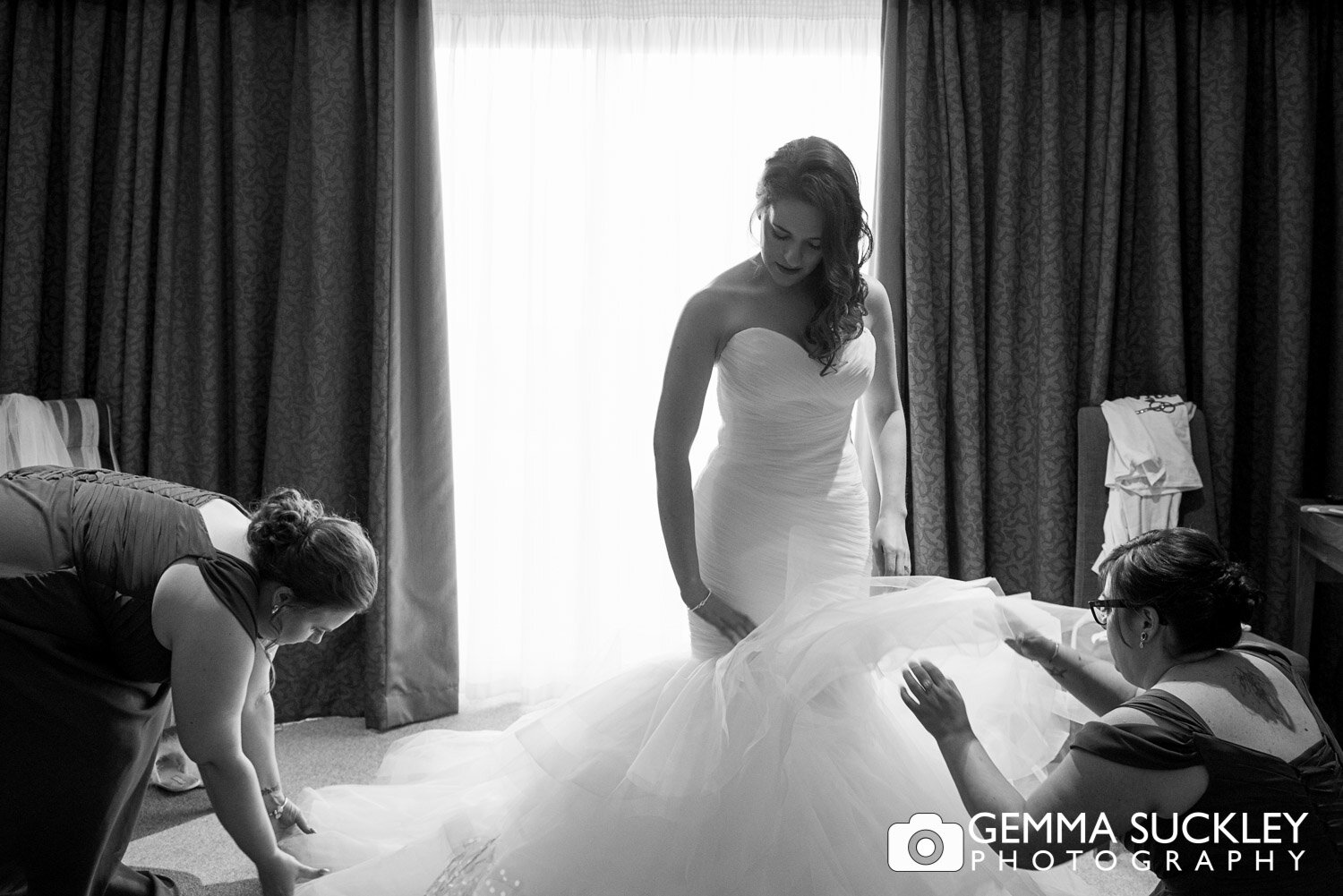 bride getting into her dress at coniston hotel 