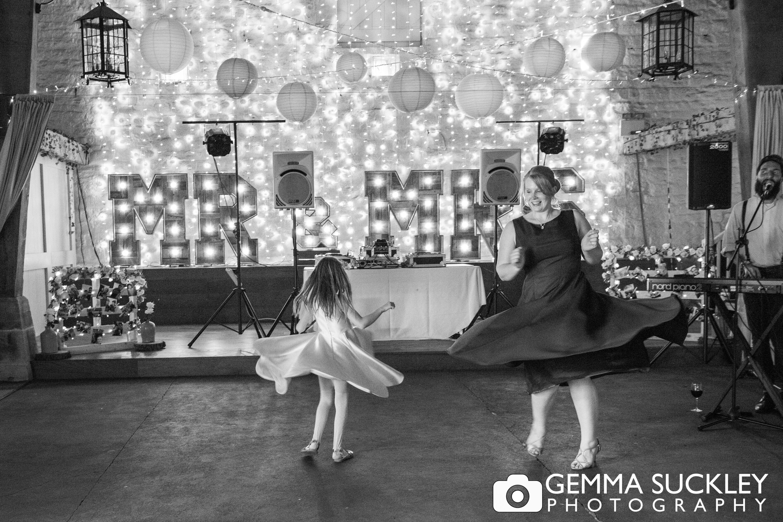 bridesmaid and flower girl spinning on the dance floor at east riddlesden hall