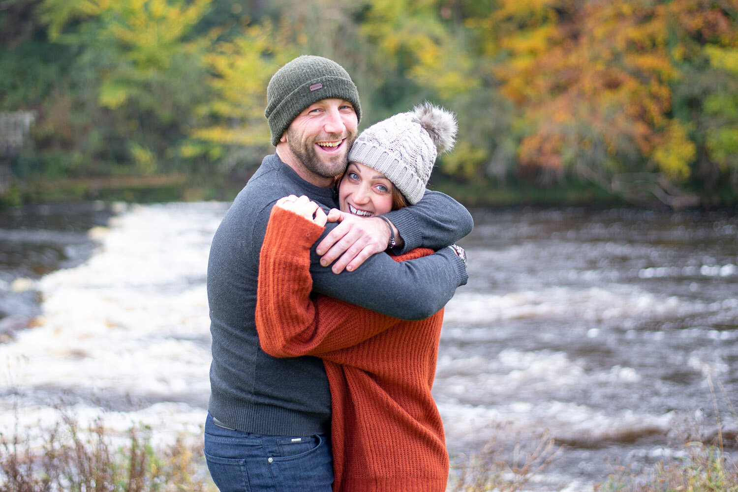 engaged couple hugging at bolton abbey