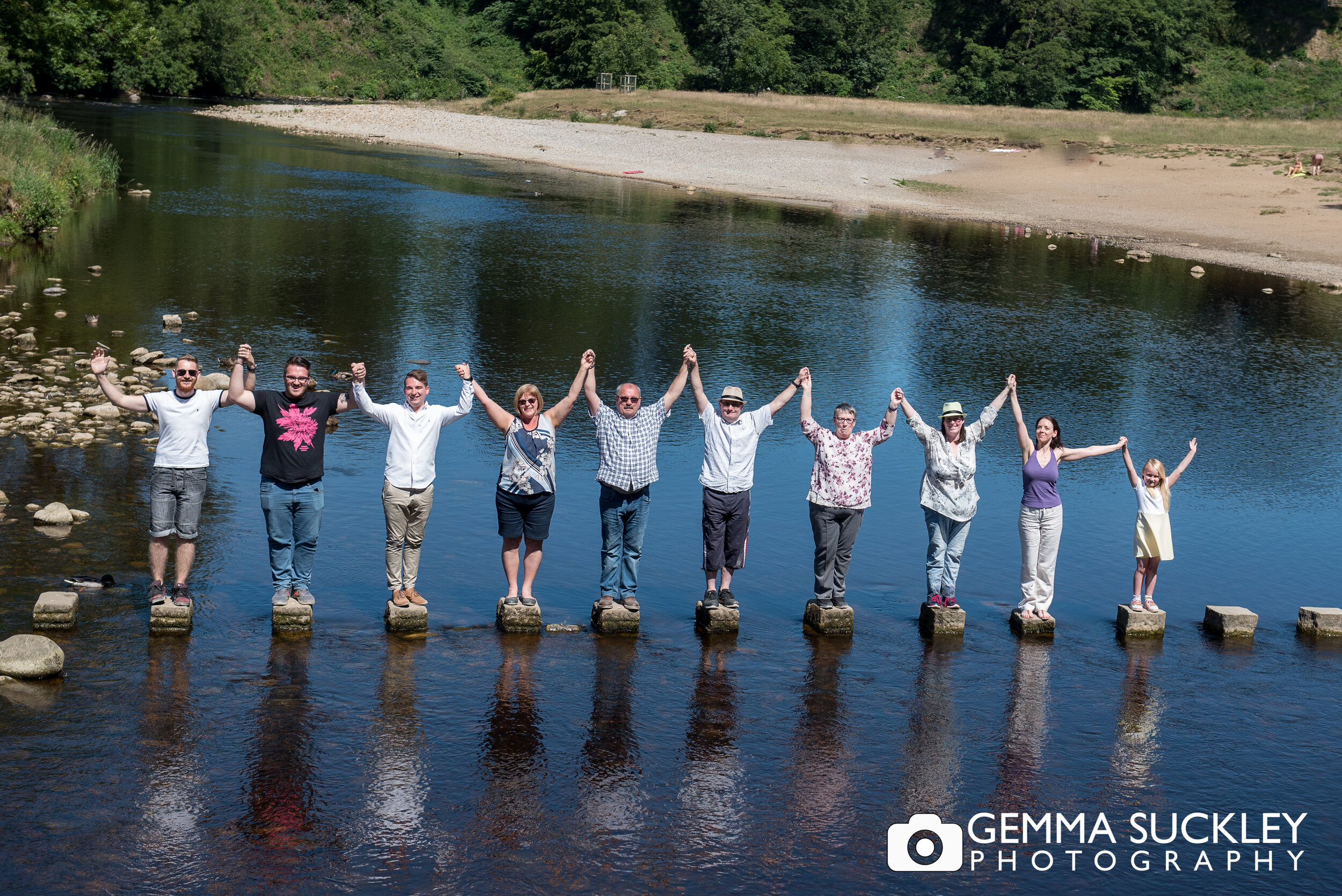 a family photo at bolton abbey on the stepping stones 