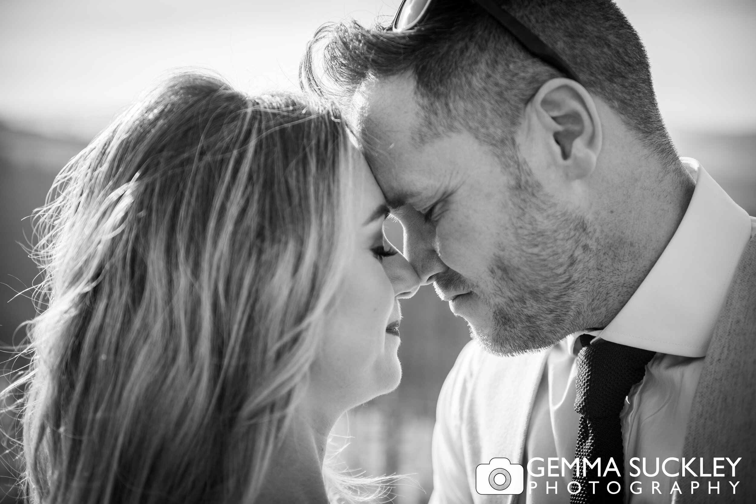 close up black and white photo of bride and groom nose to nose