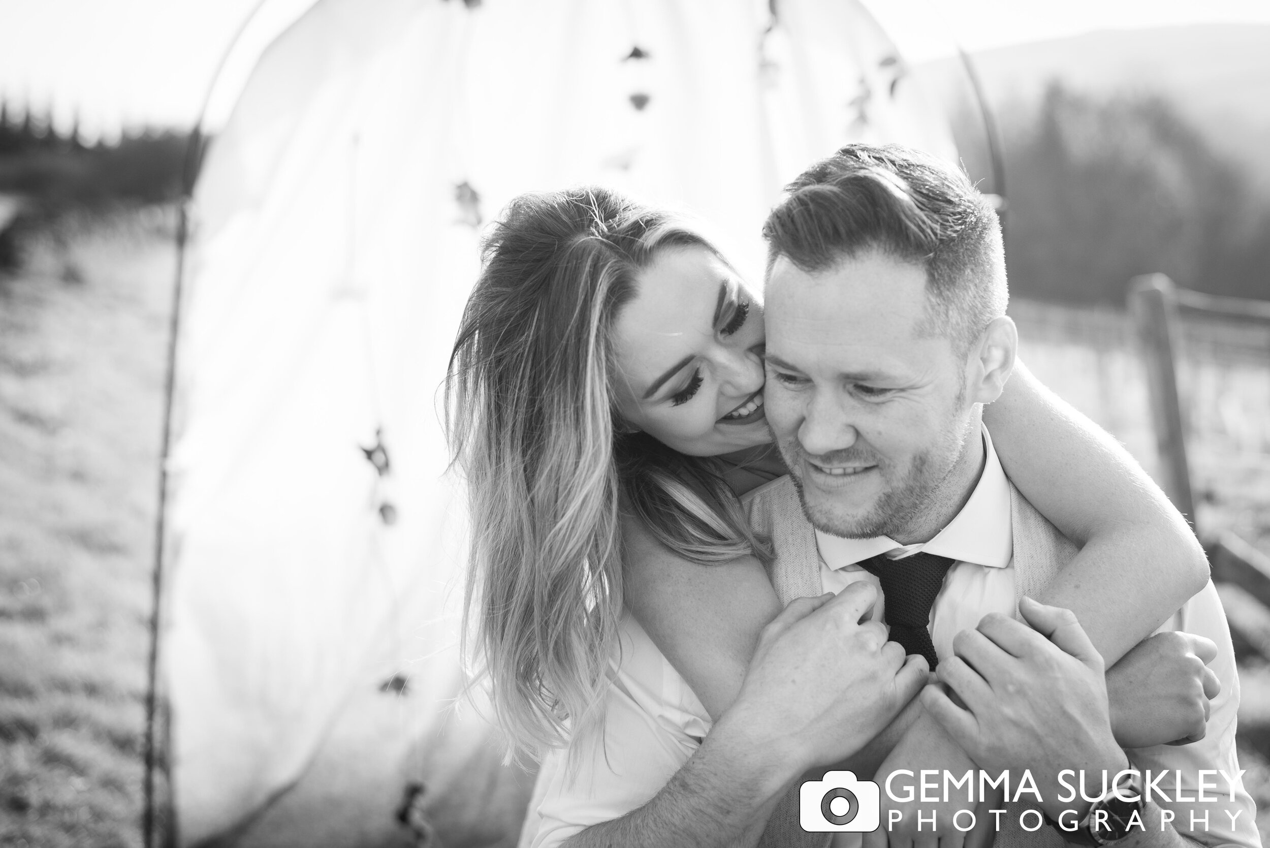 bohemian styled bride and groom laughing