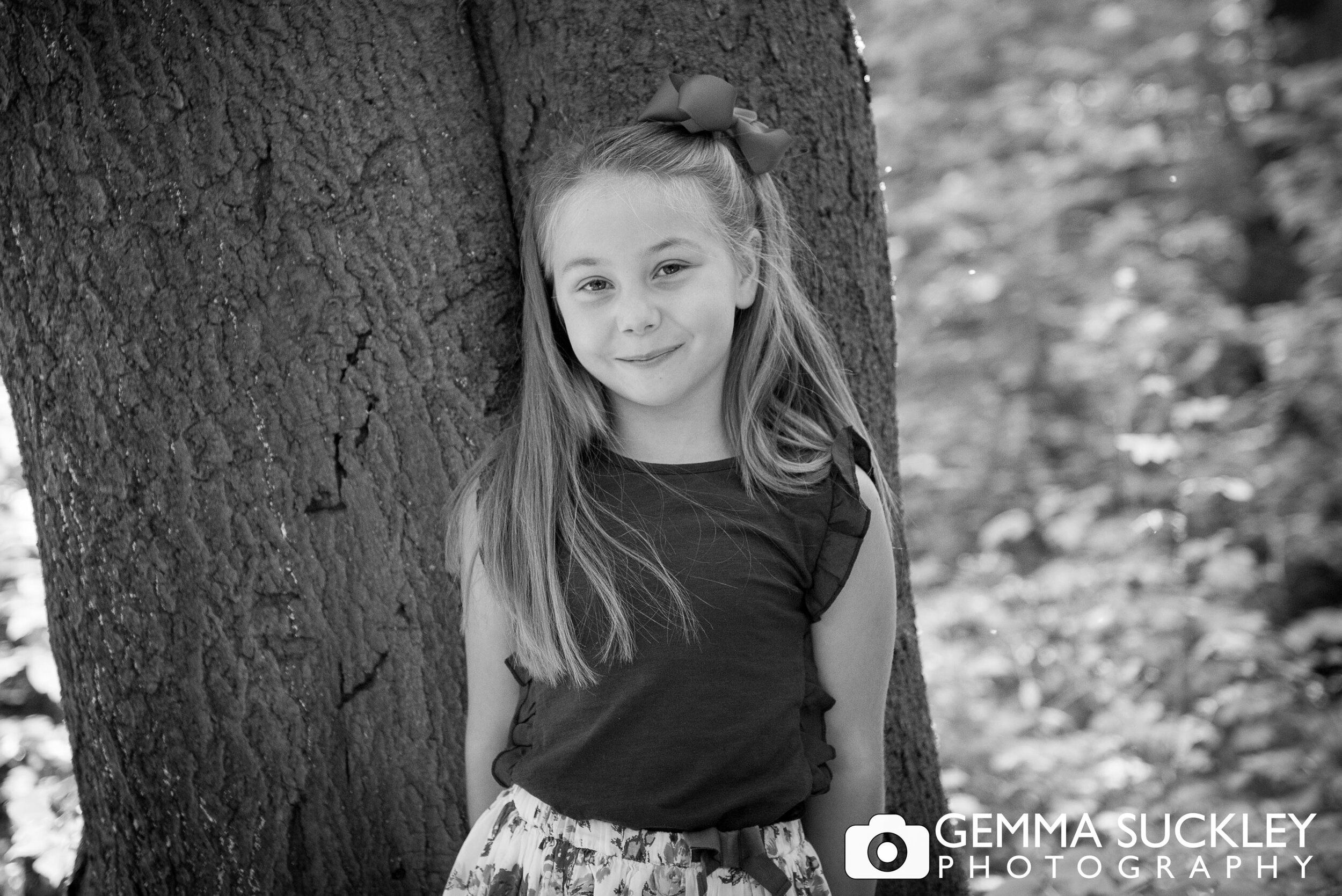 black and white photo of a little girl in sutton wood near skipton