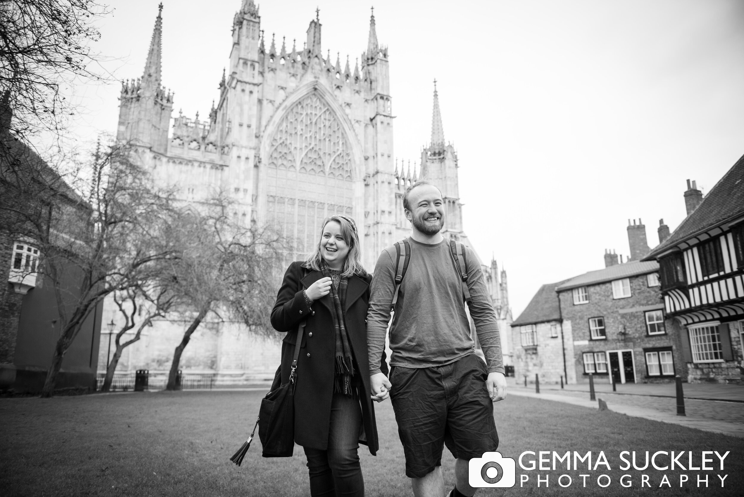  engaged couple walking in front of york minster 