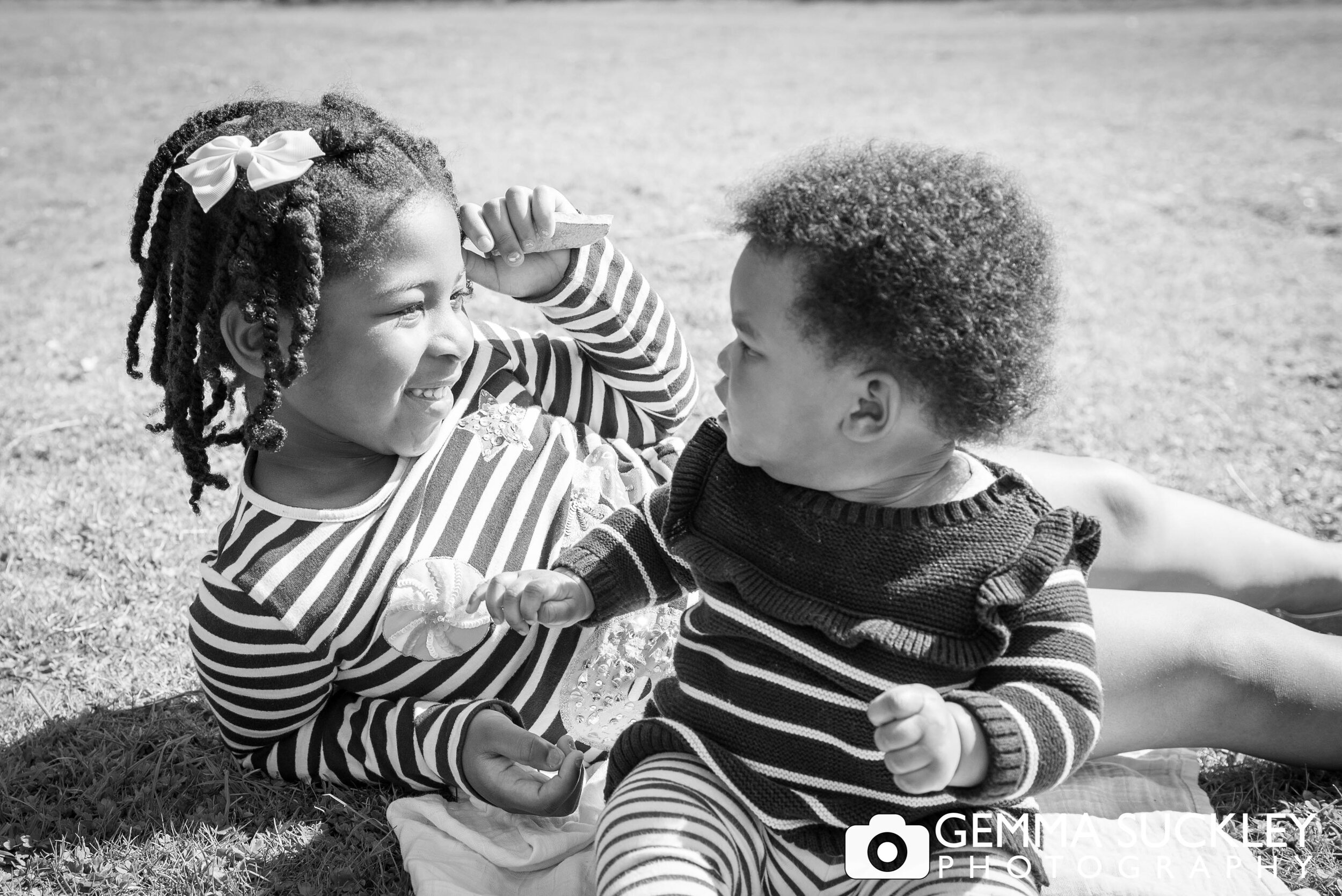 black and white photo of a little girl and her sister
