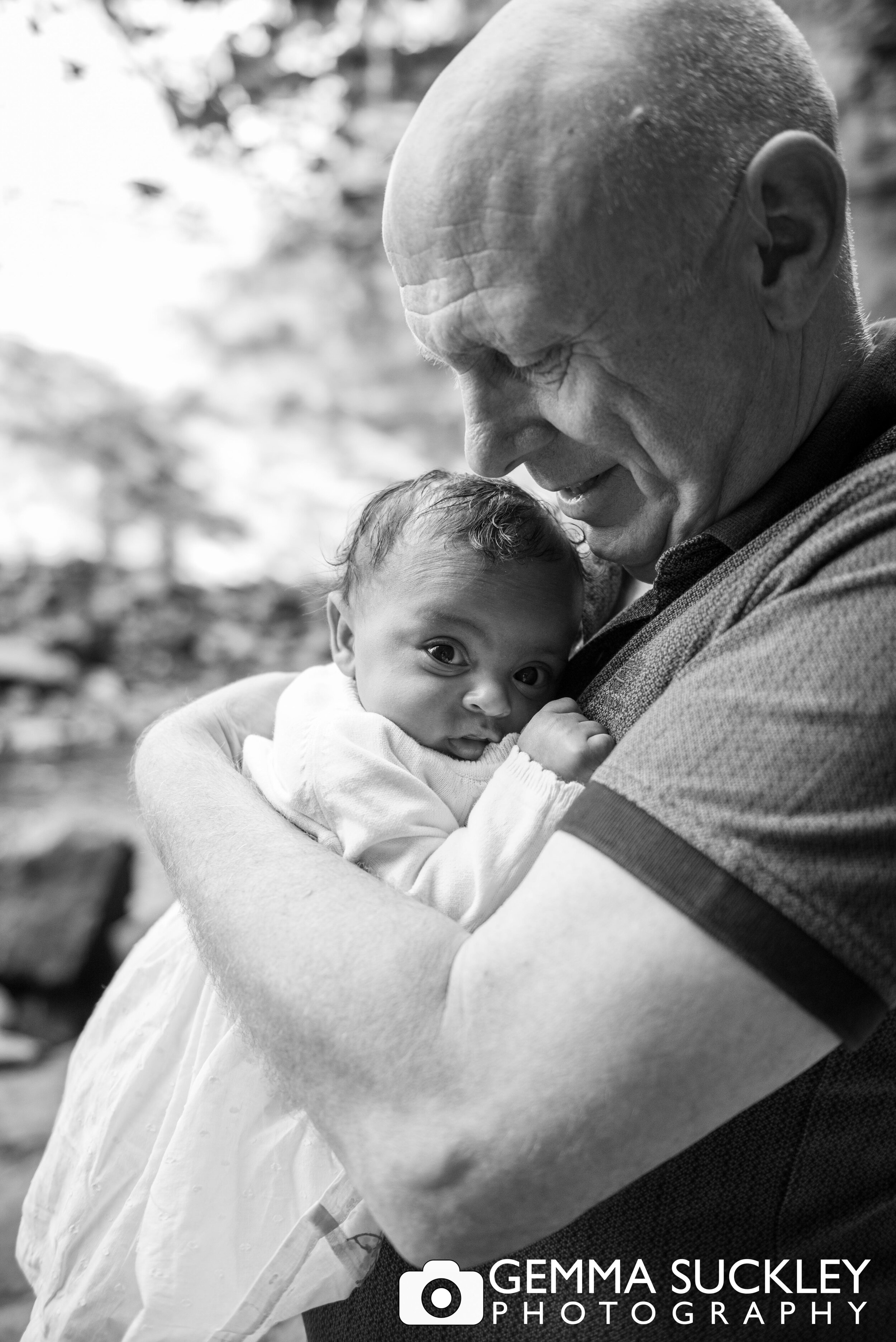 natural black and white photo of a dad and his newborn baby