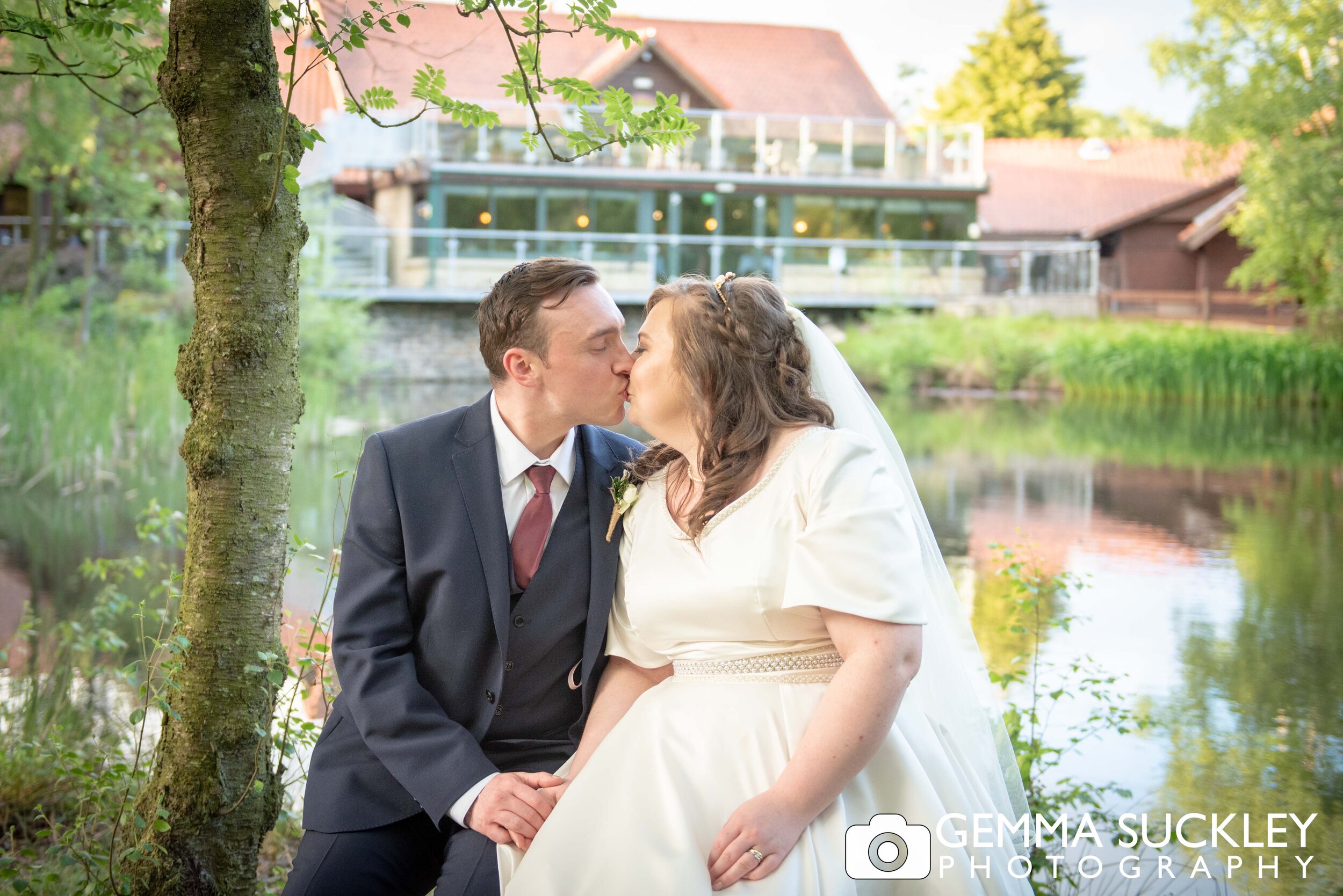 wedding photo of otley bride and groom with chevin country park hotel in the background