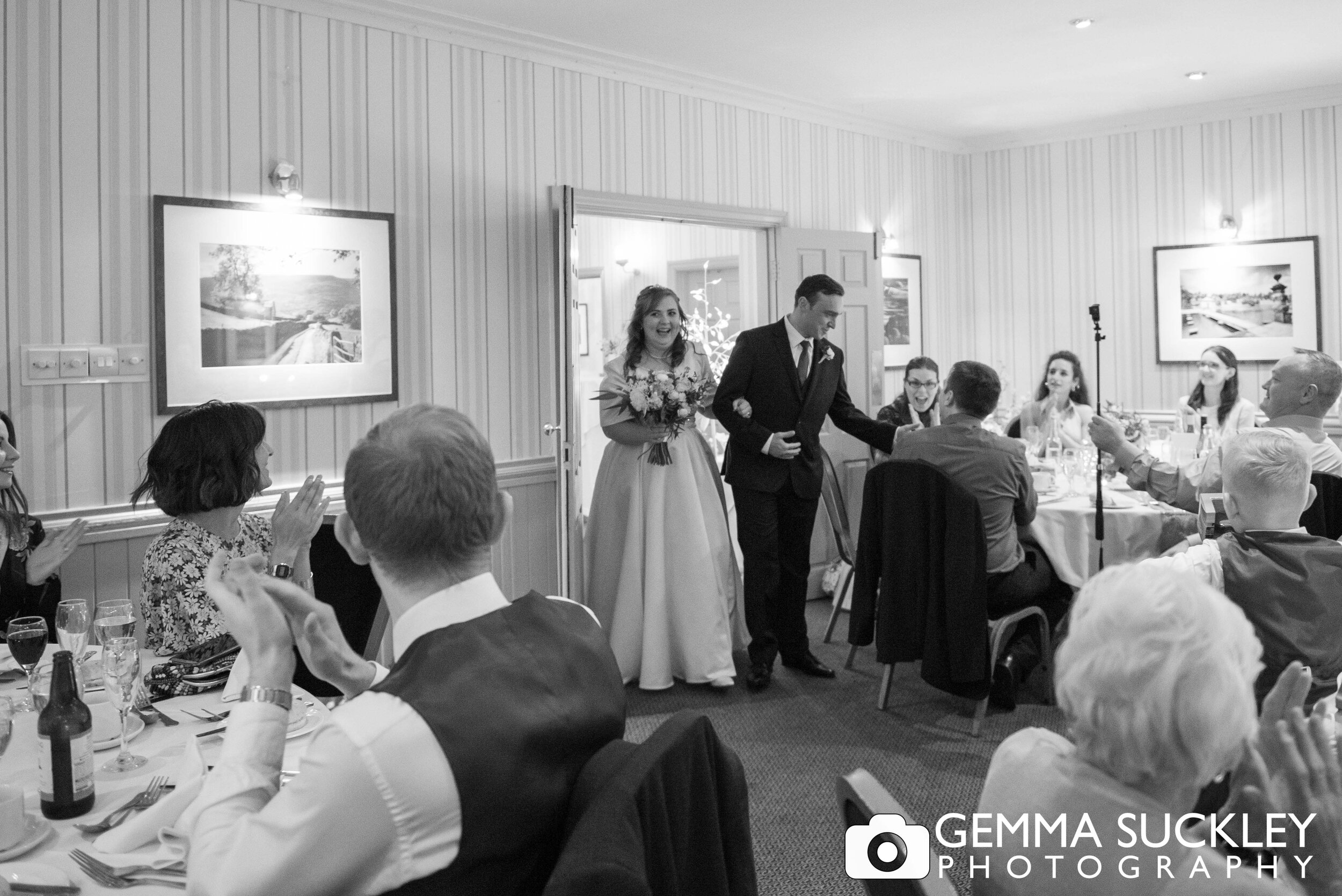 the bride and groom entering the wedding breakfast room at otley chevin country park hotel