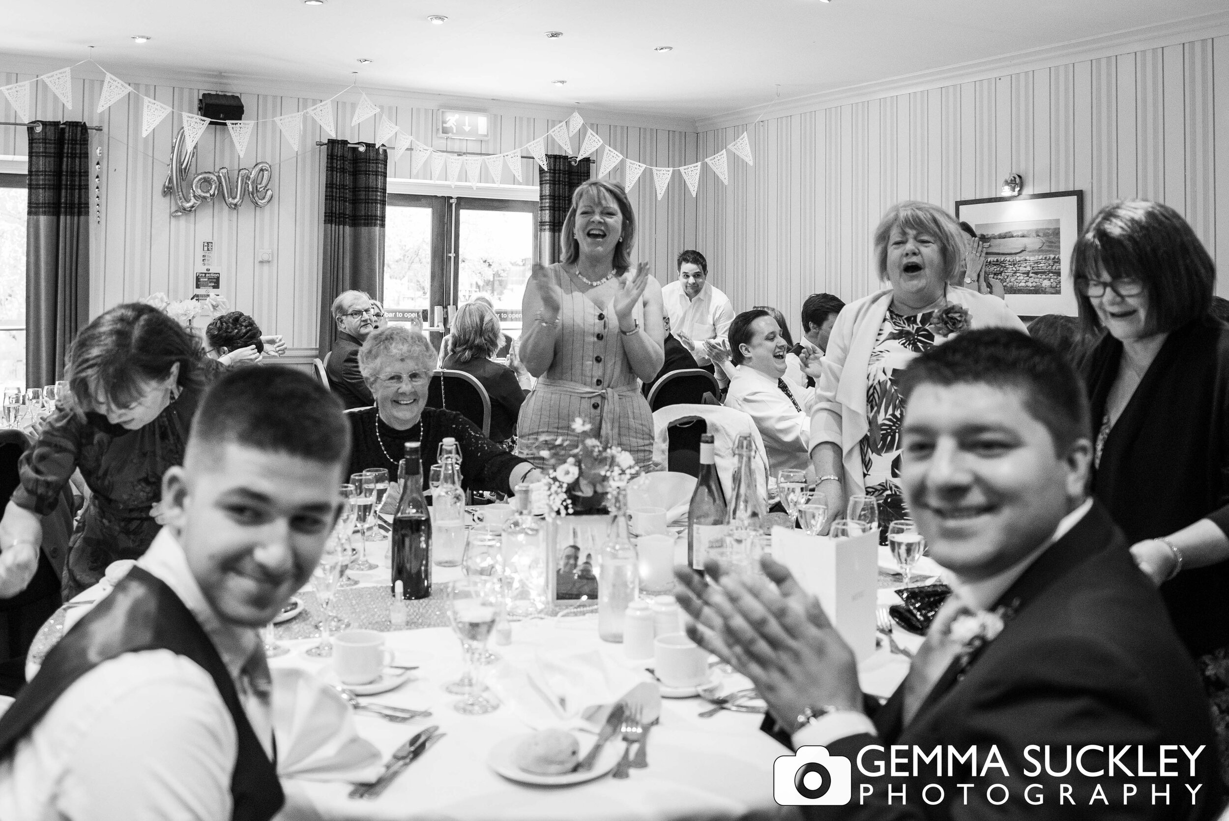 guest applauding as the bride and groom enter the room at otley chevin hotel