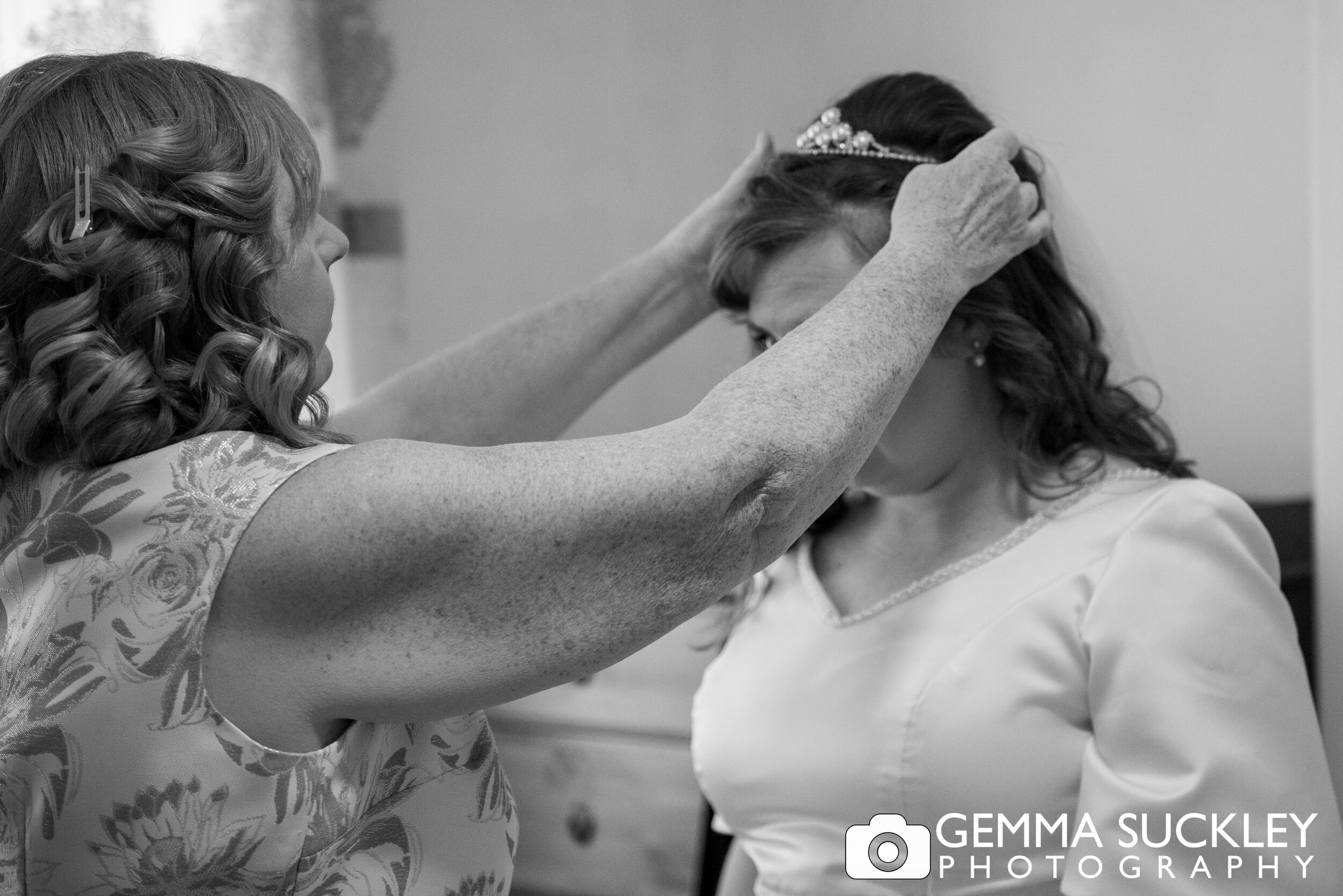 mother of the bride fixing the bride veil