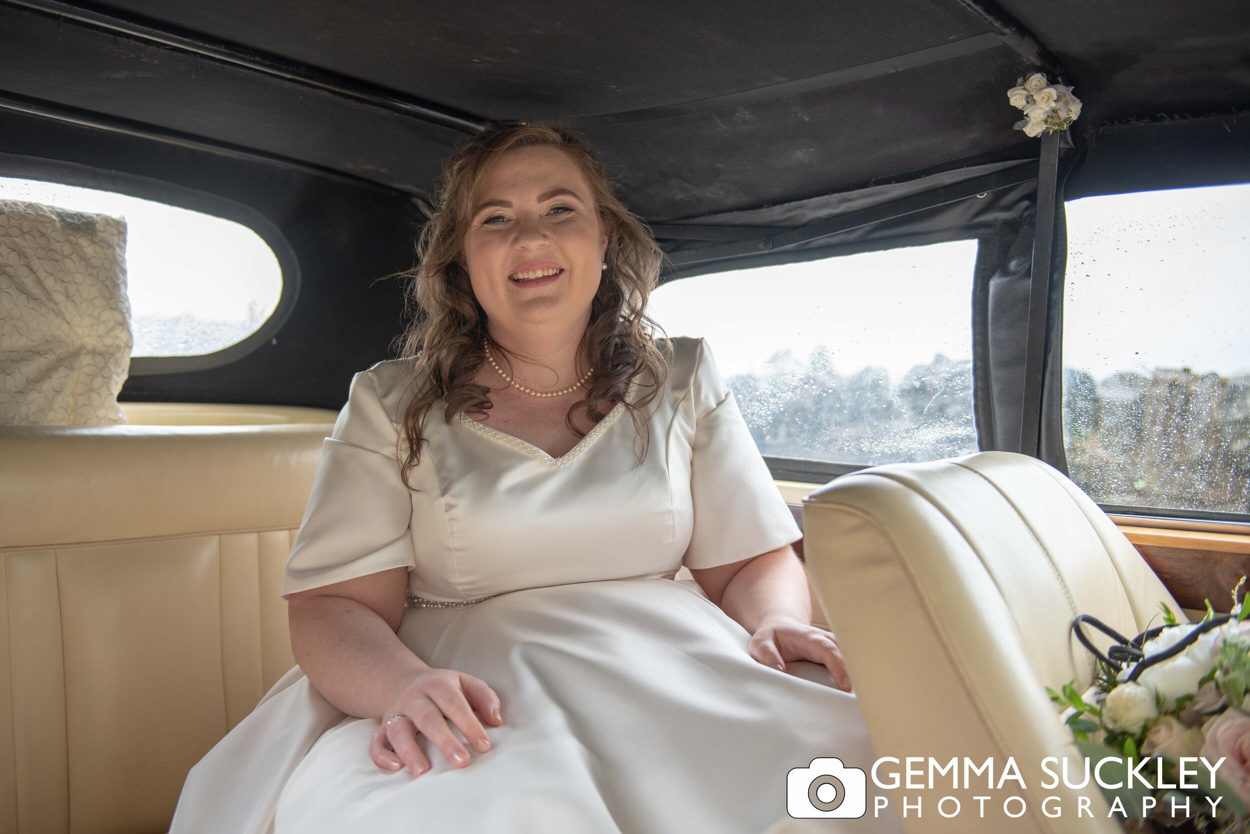 bride arriving at the church in a vintage wedding car 