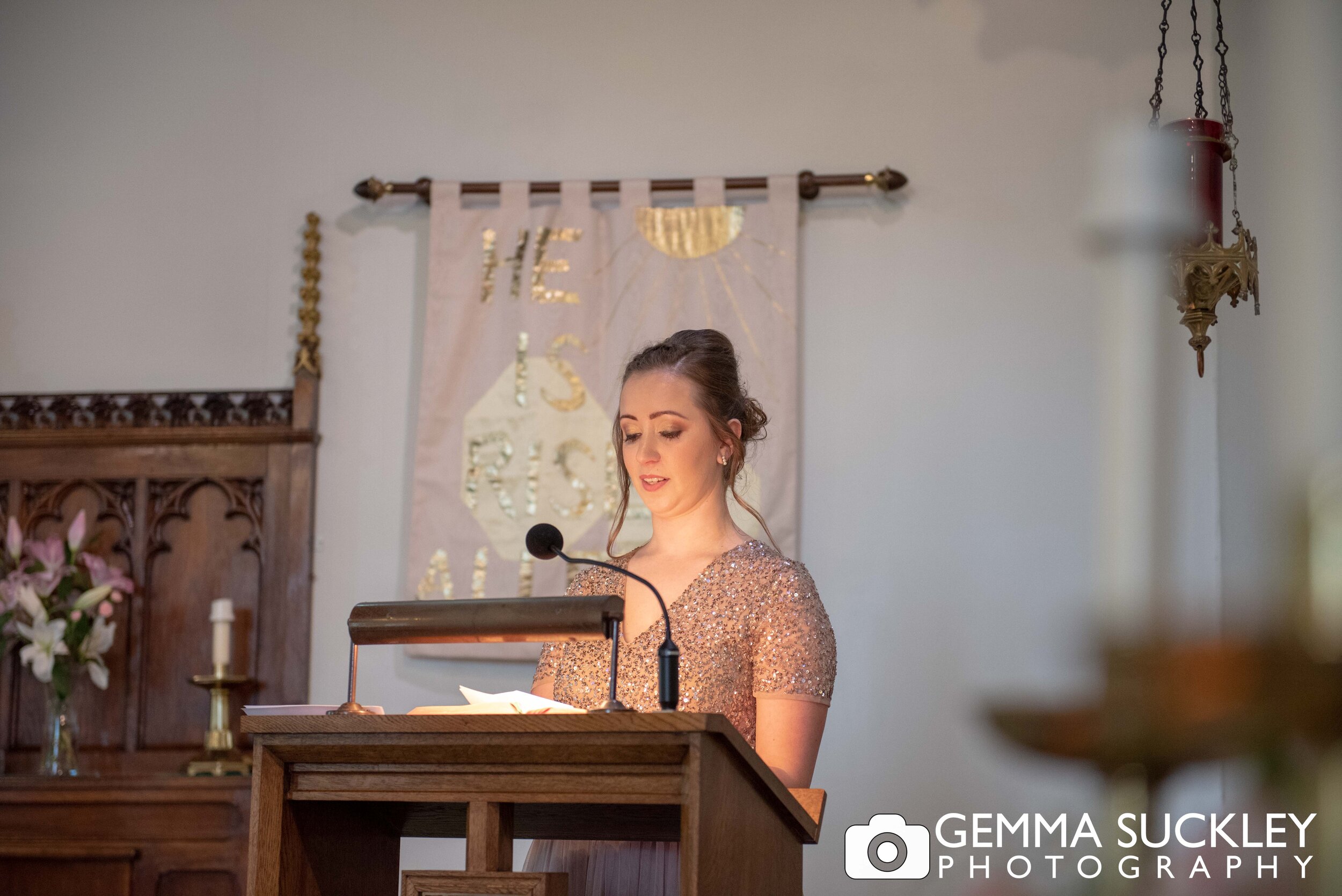 bridesmaid in haworth church doing a reading 