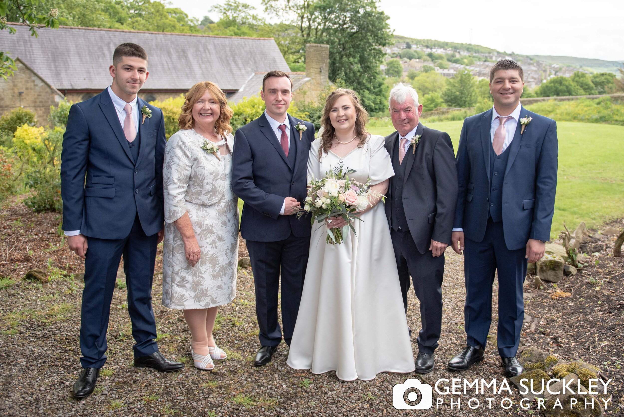formal wedding photo of the bride and groom with family
