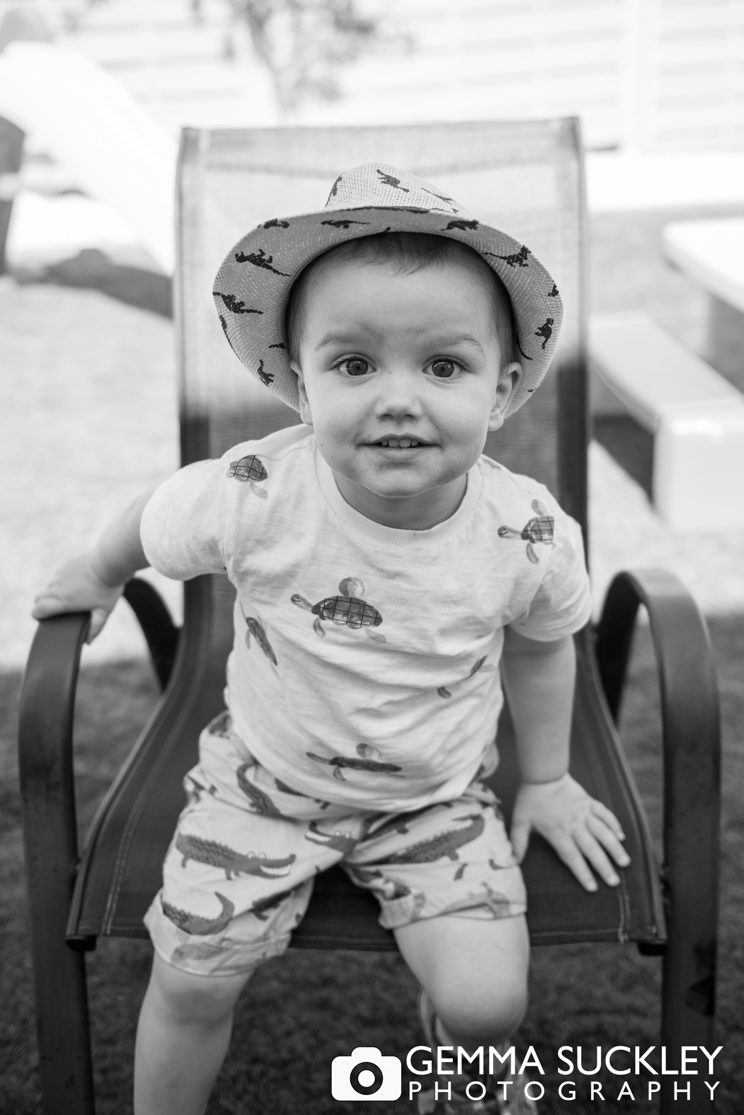 black and white photo of a little boy smiling at the camera