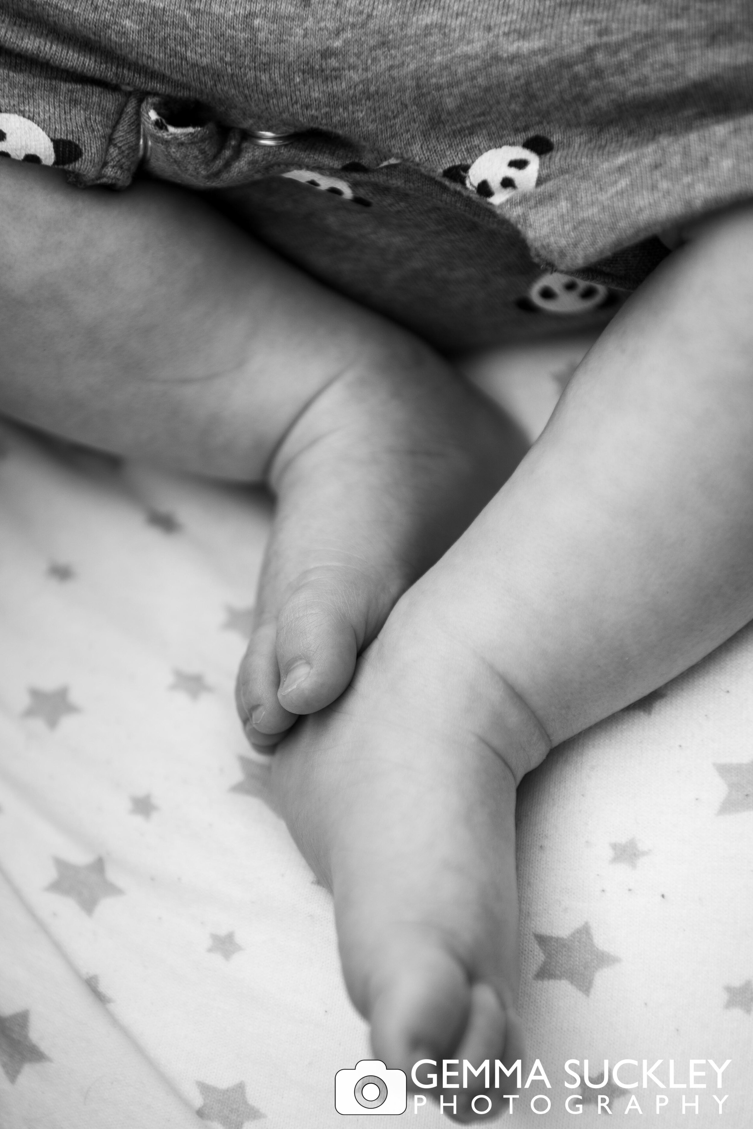 black and white photography of baby feet