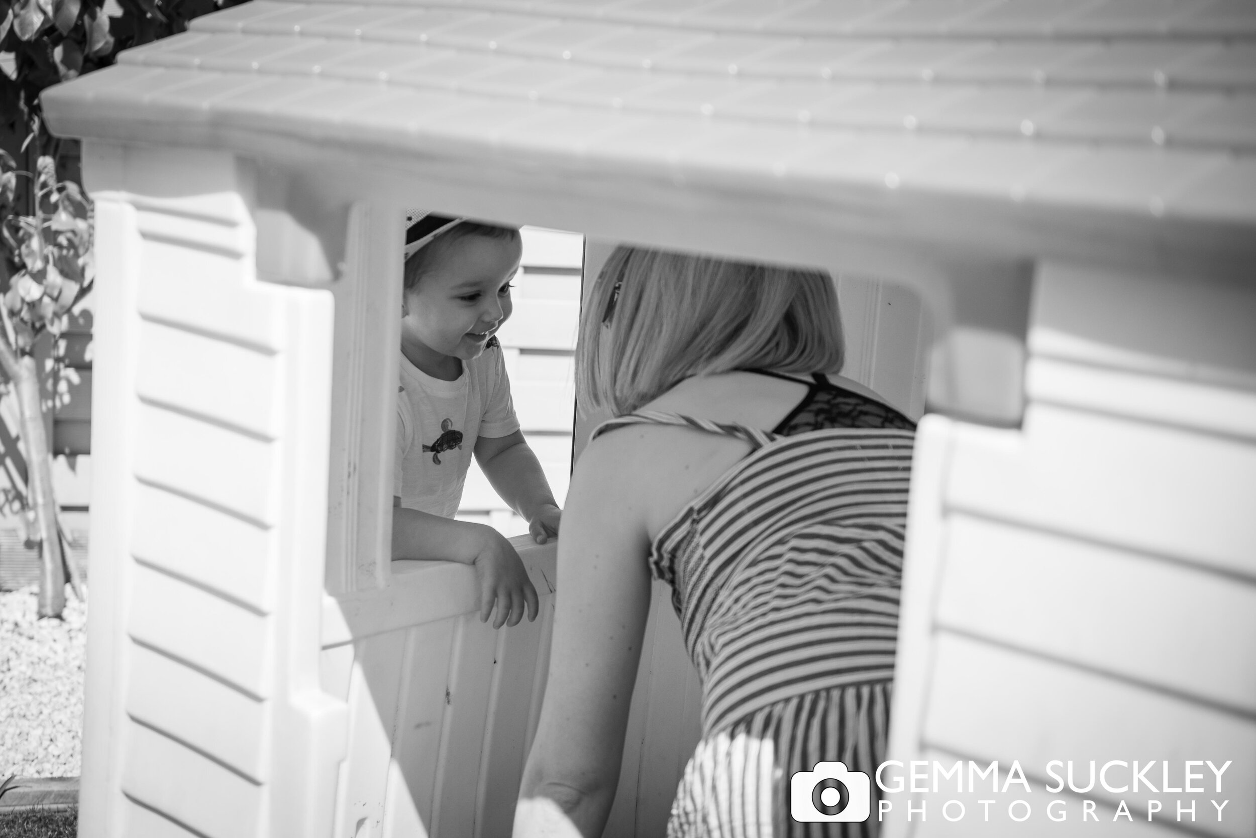 mum and son playing in his wendy house