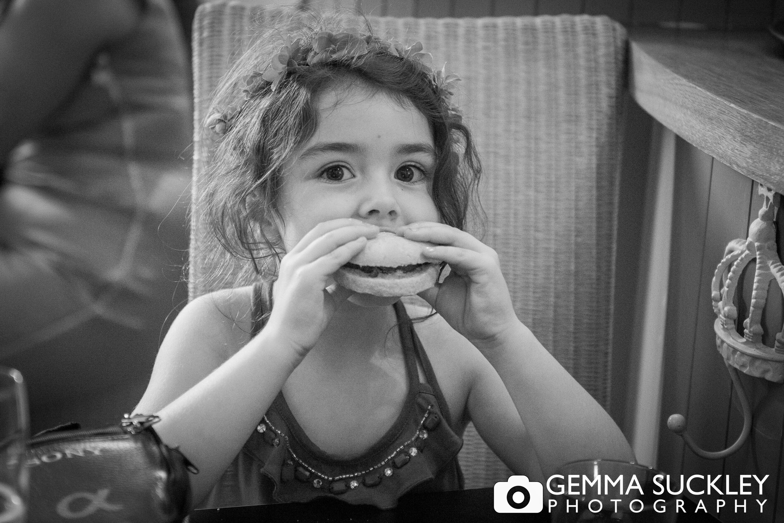 little girl eating a burger at a harrogate wedding