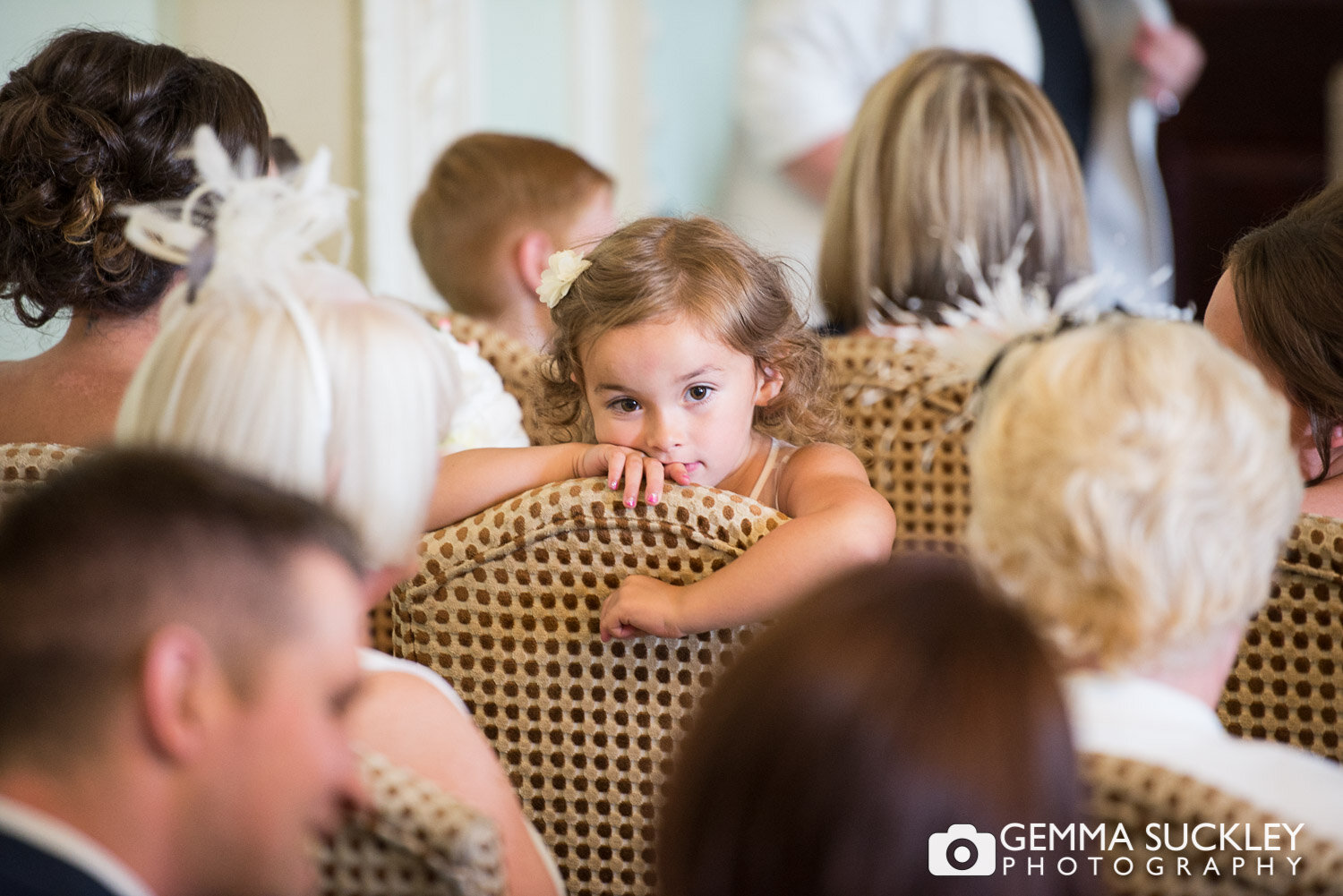 little girl turned in her chair waiting patiently for the bride to walk down the aisle