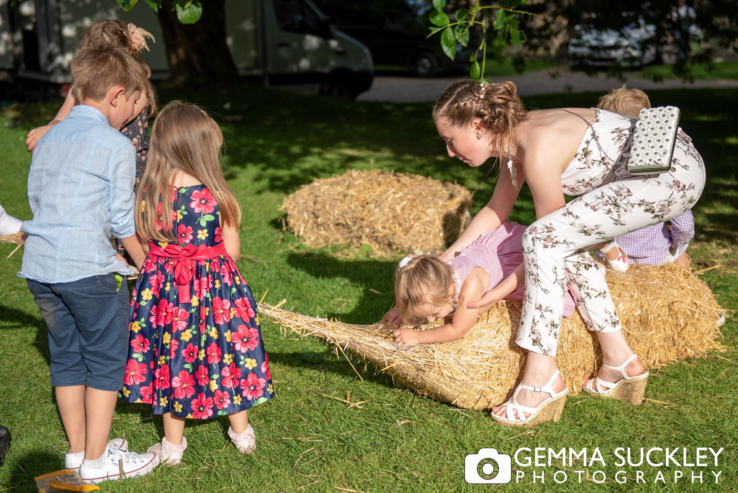 children pulling a hay bile apart at east riddlesden wedding