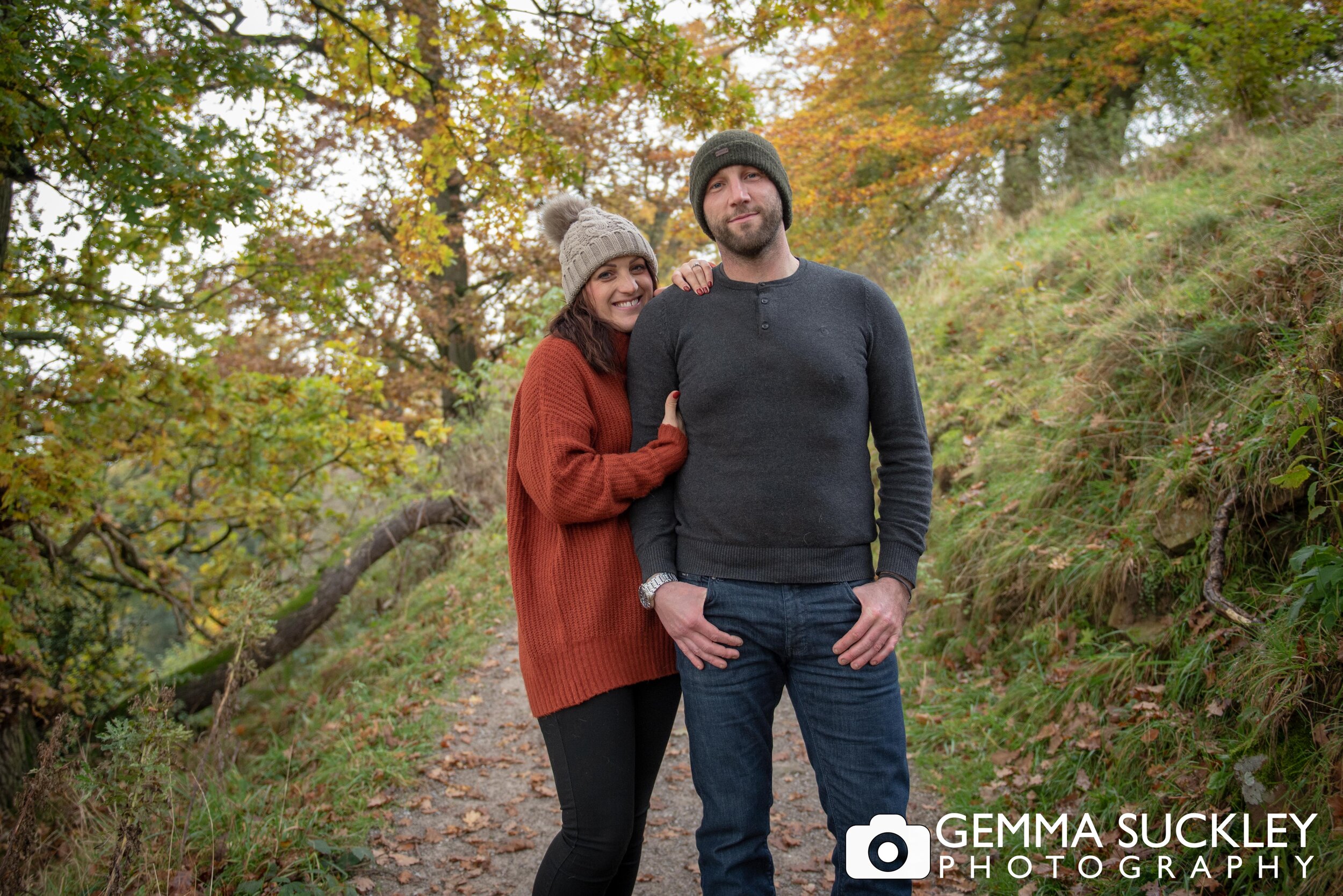 a smiling couple on their engagement photo shoot at bolton abbey 