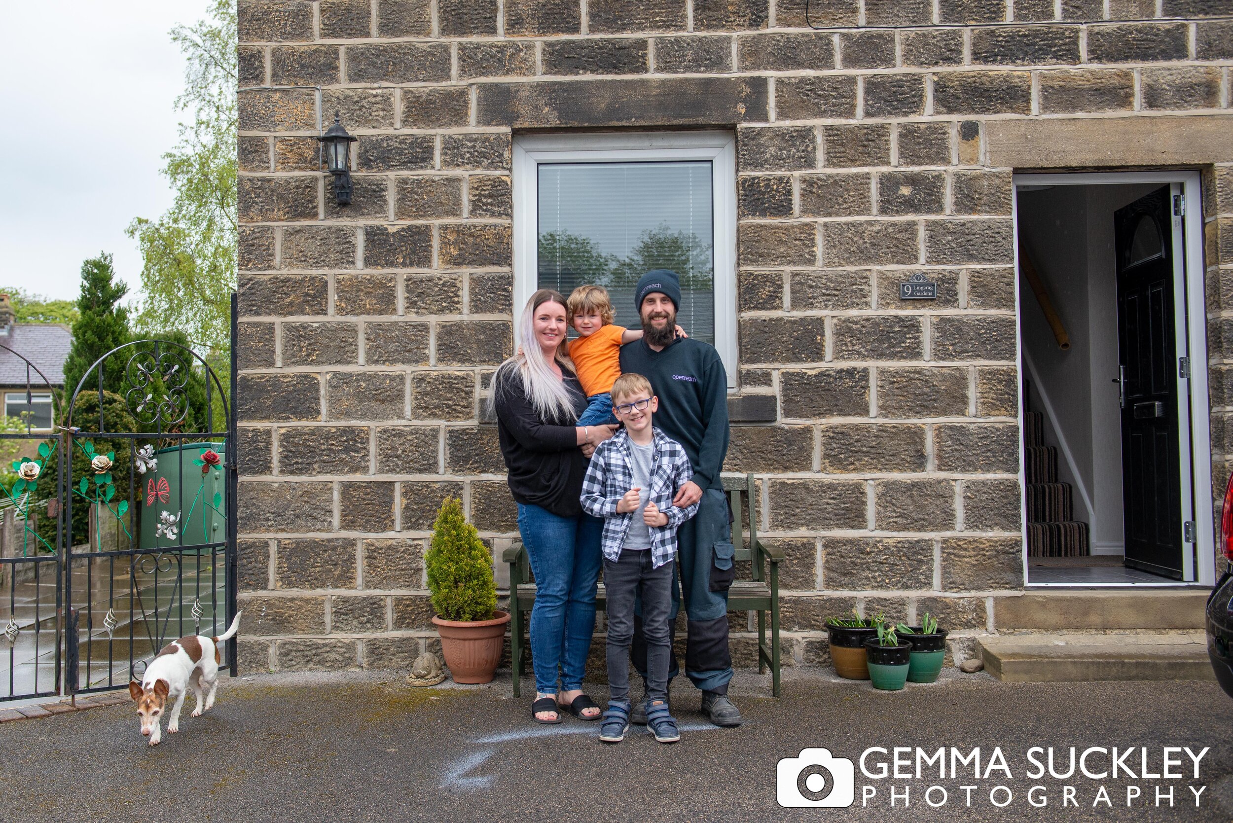 cowling family smiling with their dogs for a doorstep photo