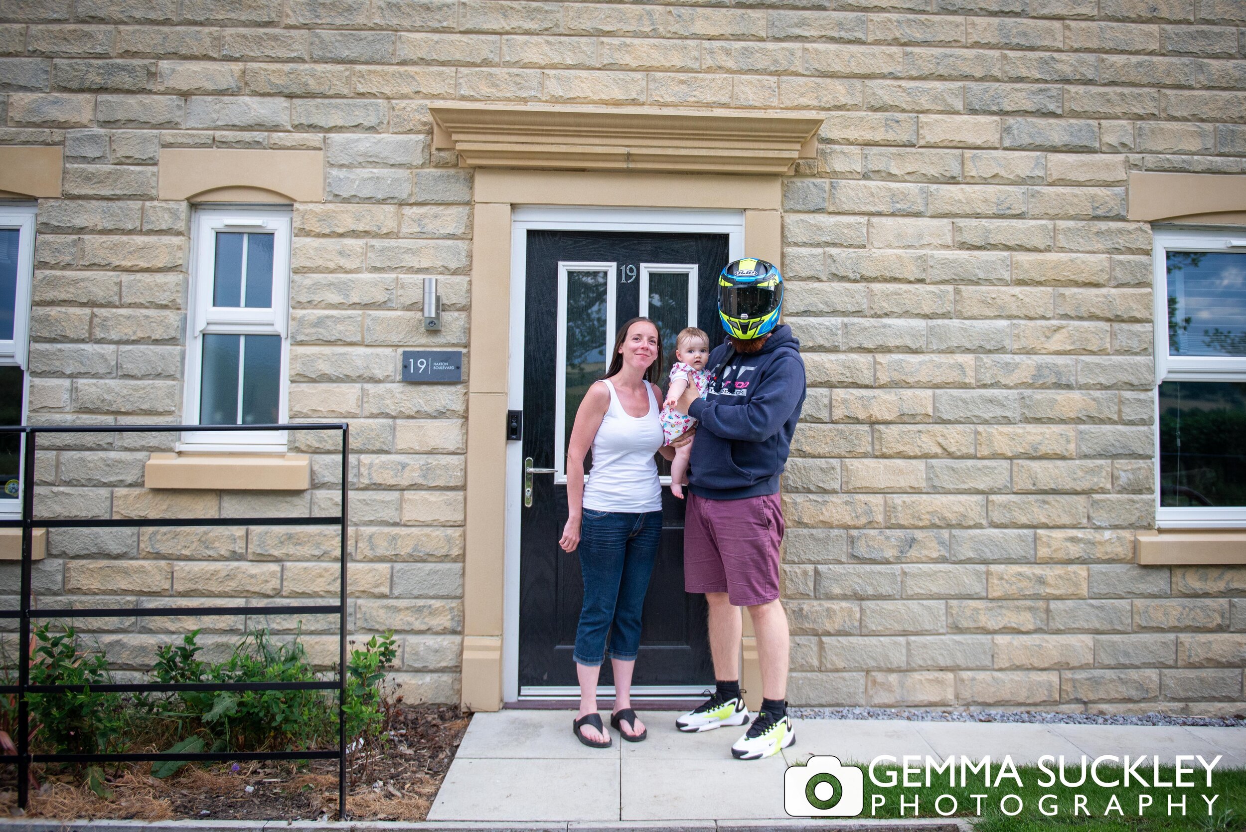 doorstep portrait of a steeton couple with a baby. 