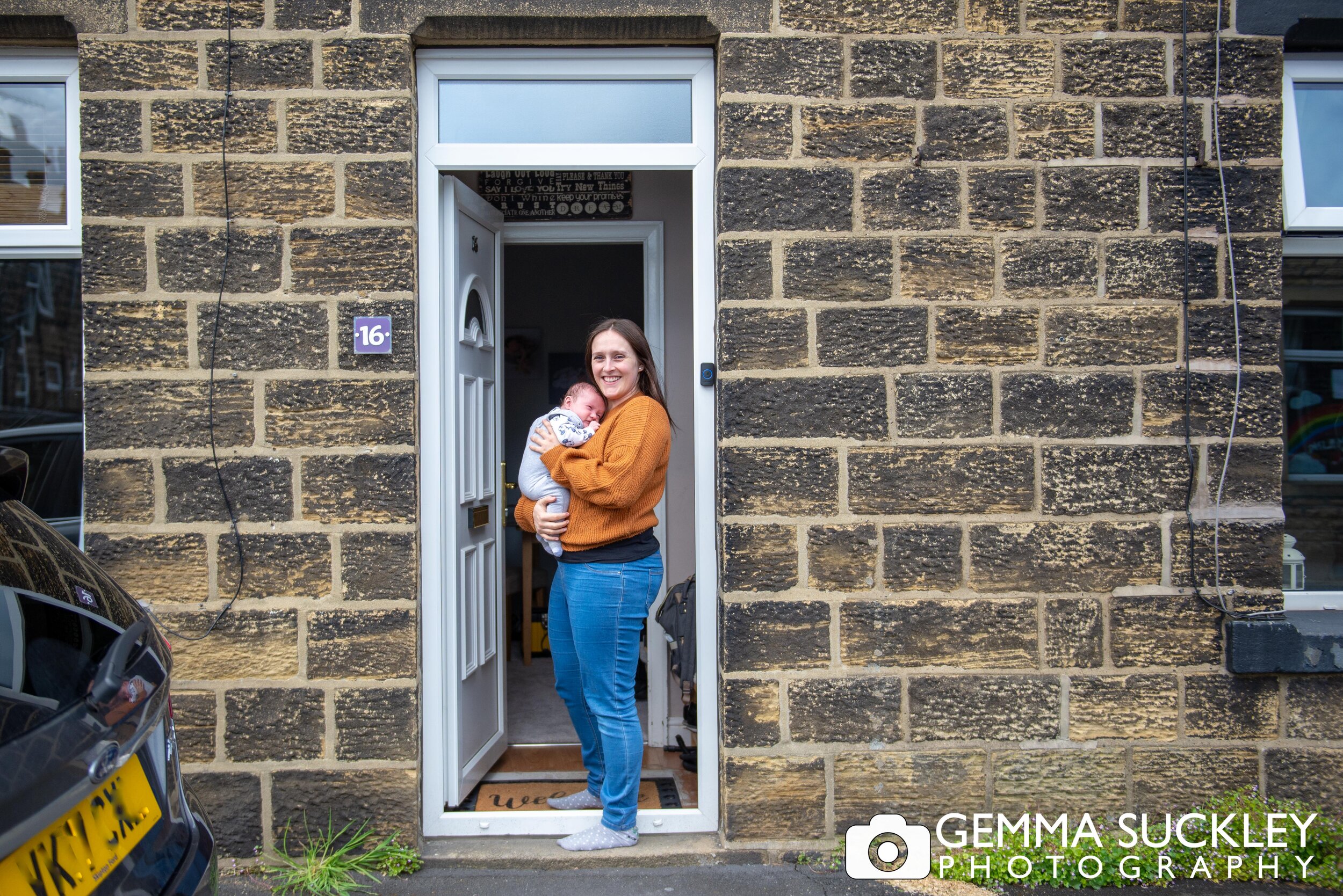 a doorstep portrait for a young mum and her newborn baby in cross hills
