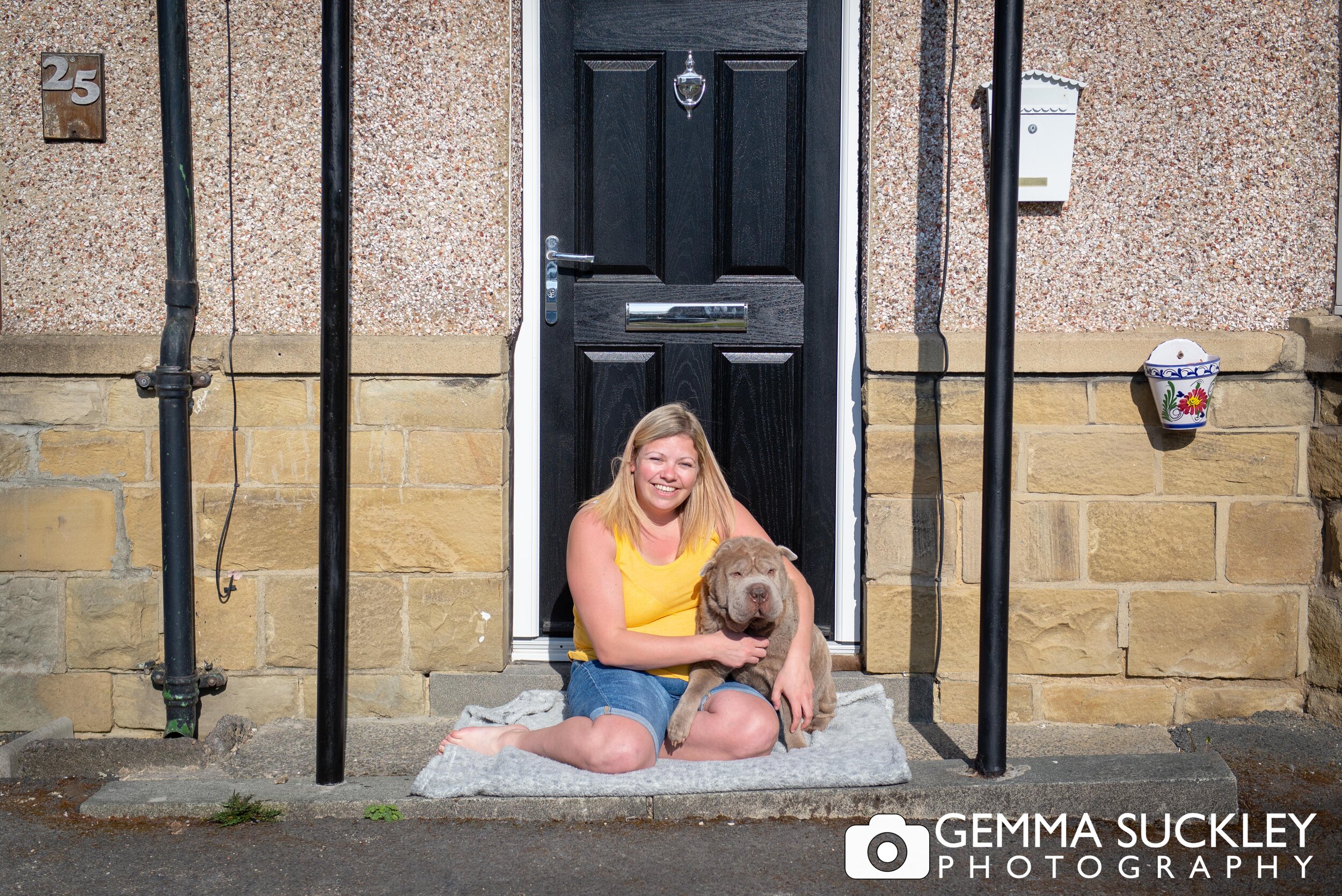 a gilf sitting on her doorstep with her dog