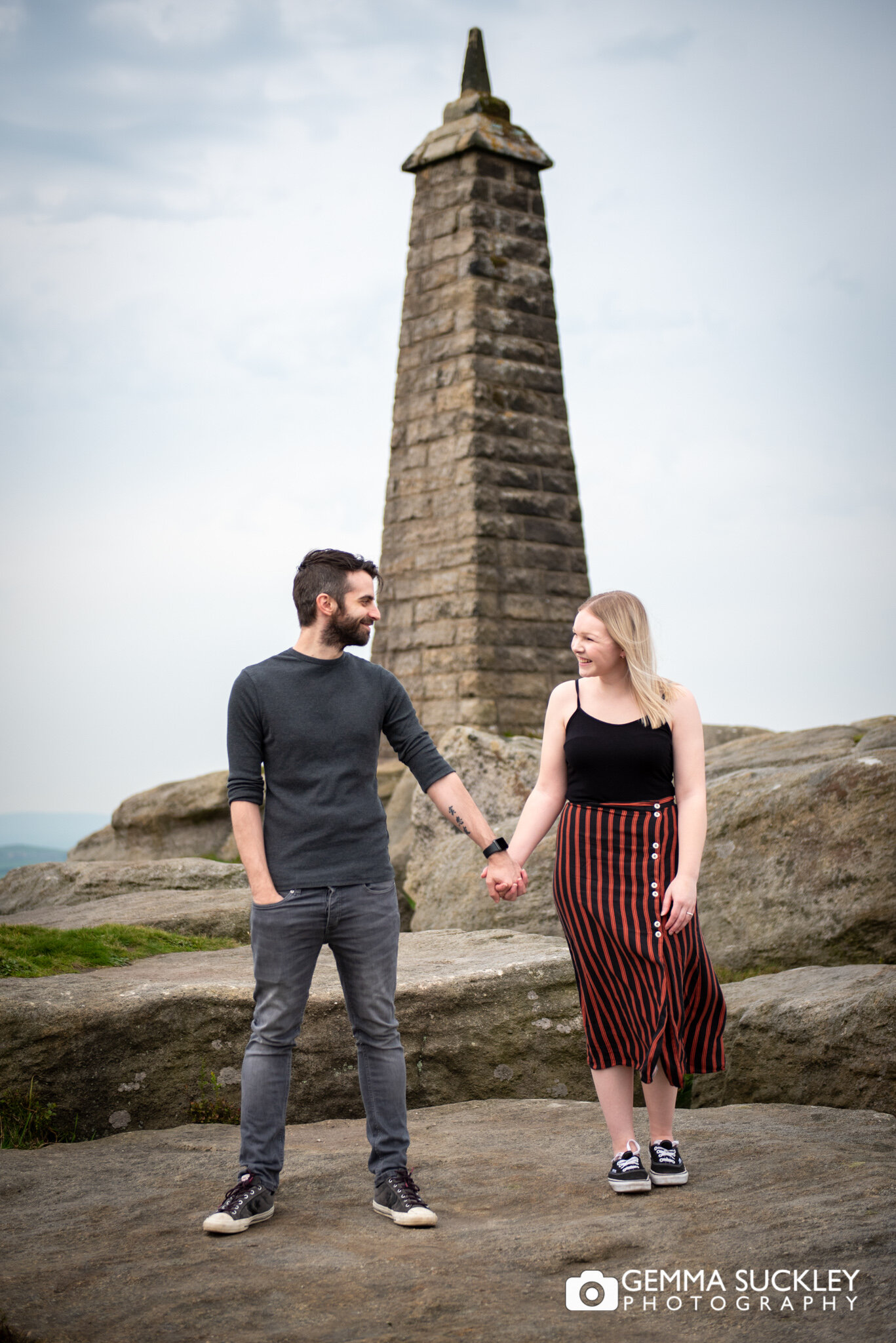 a couple holding hands with cowling pinnacle behind them