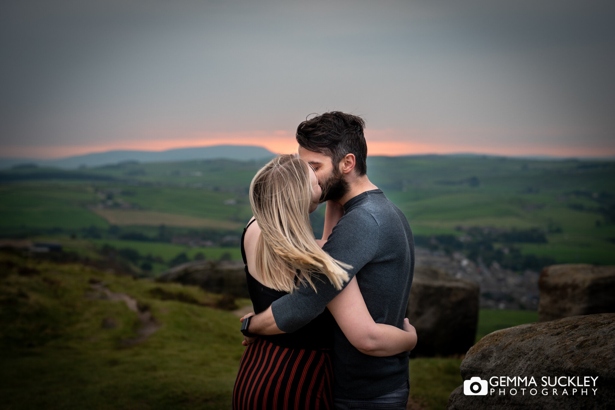 a couple kissing with the sun setting in north yorkshire