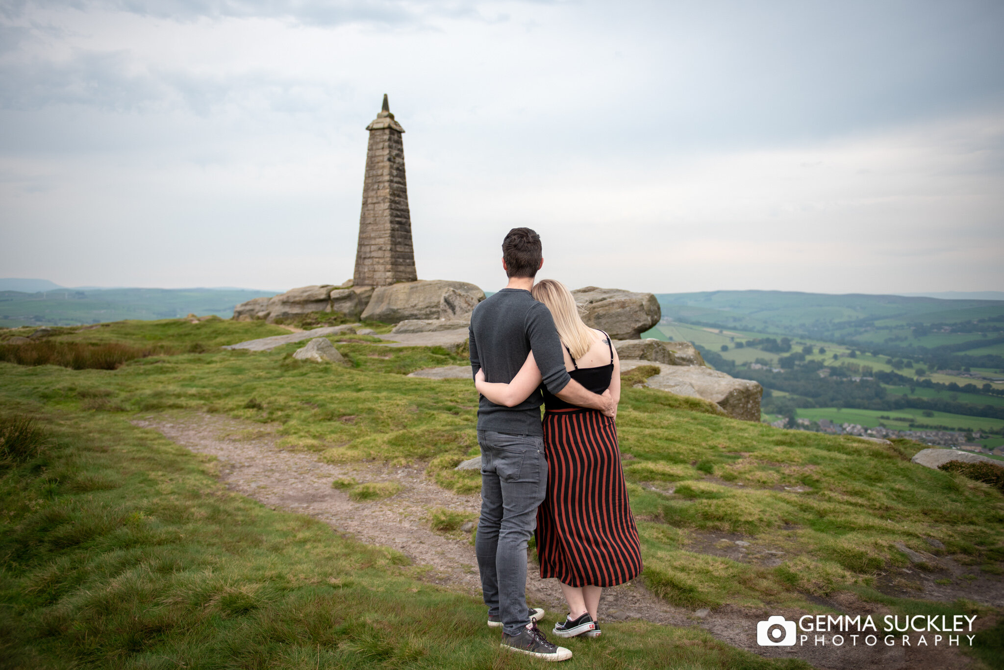 engaged couple looking out over cowling pinnacle