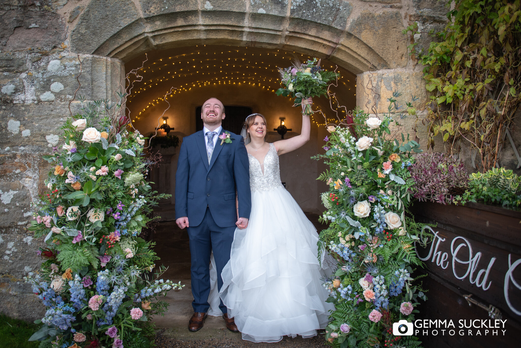 a just married couple looking relived to tie the knot at the priest house at barden tower
