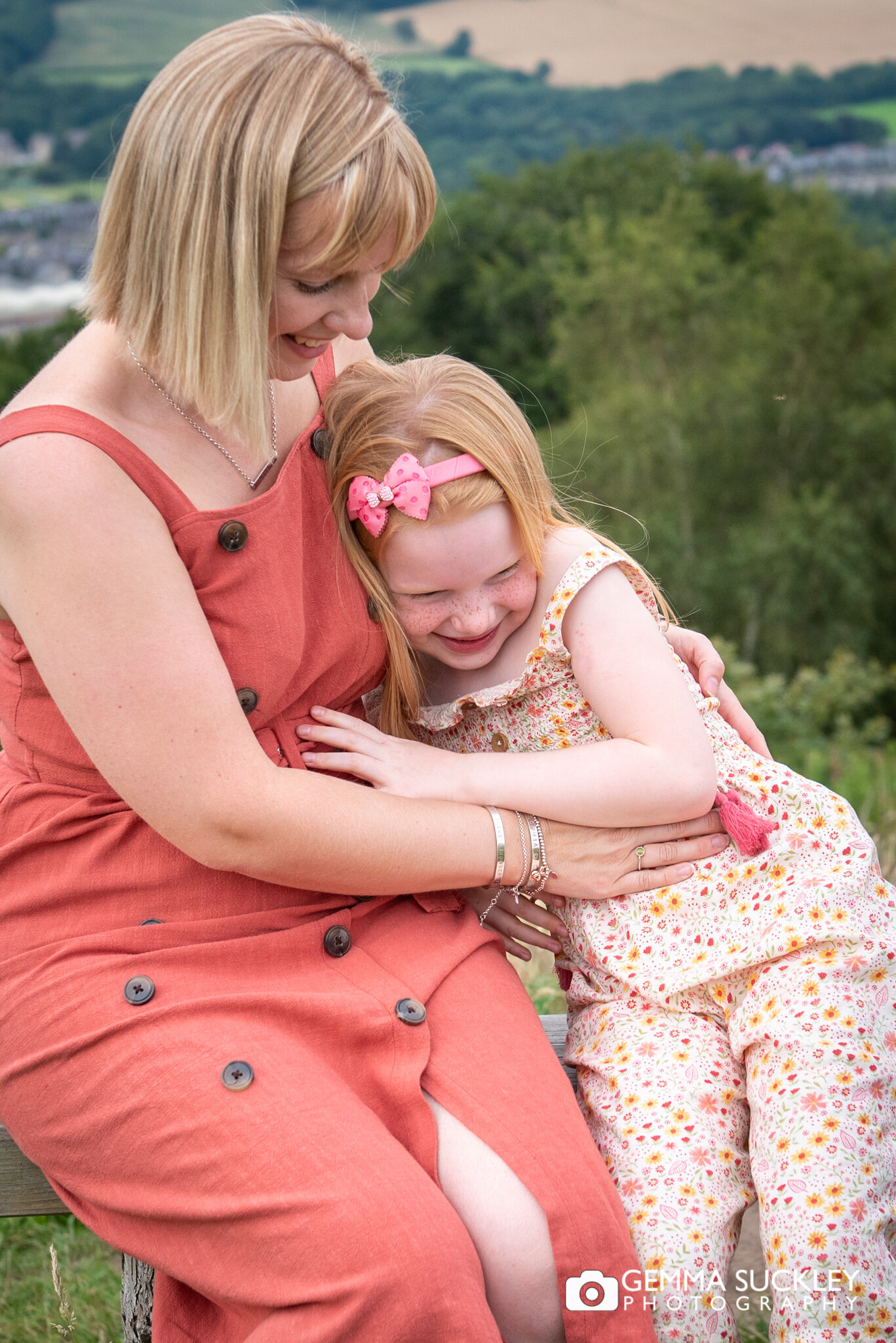 a mother cuddling her little girl during a photoshoot at the otley chevin