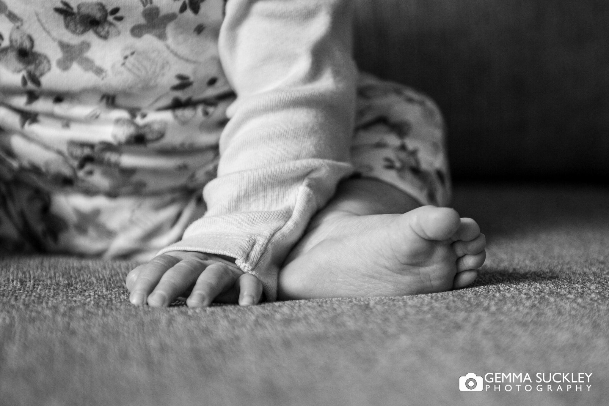 black and white close up photo of a newborn bab's foot 