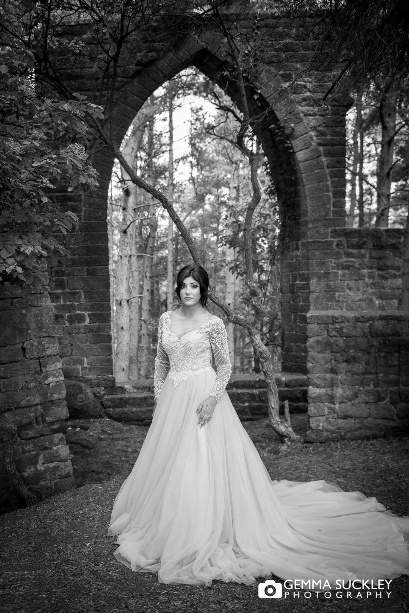 a brides portrait with a ruin in the background