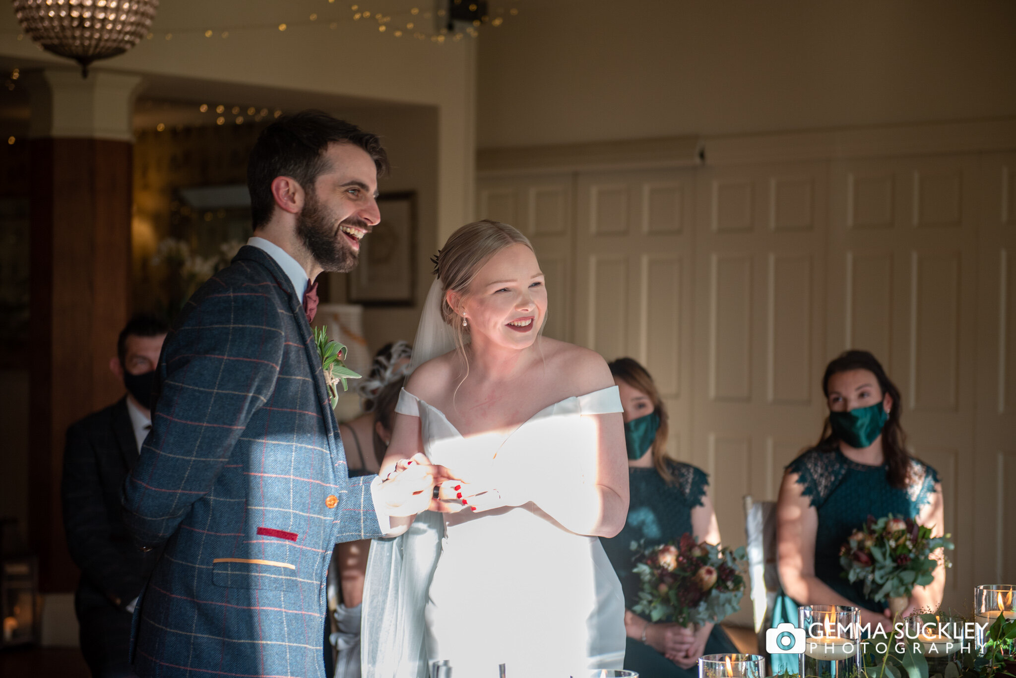 a bride and groom laughing while saying their vows at the shireburn hotel in clitheroe 