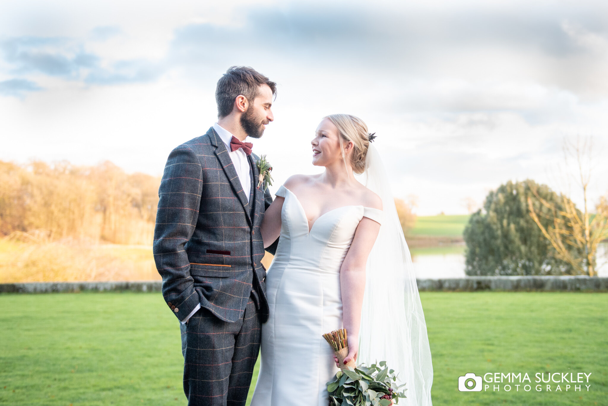 a bride and groom at the lake at coniston hotel 