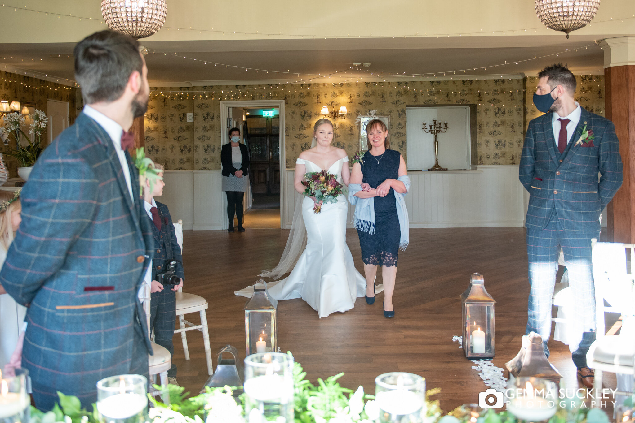 a bride walking down the aisle at the shireburn arms in clitheroe
