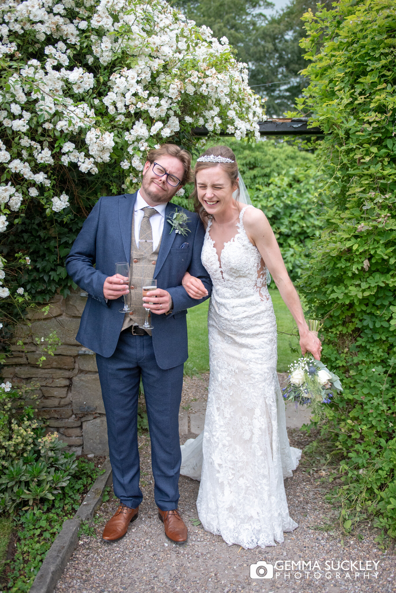 bride and groom laughing sounding my flowers at east riddlesden halll