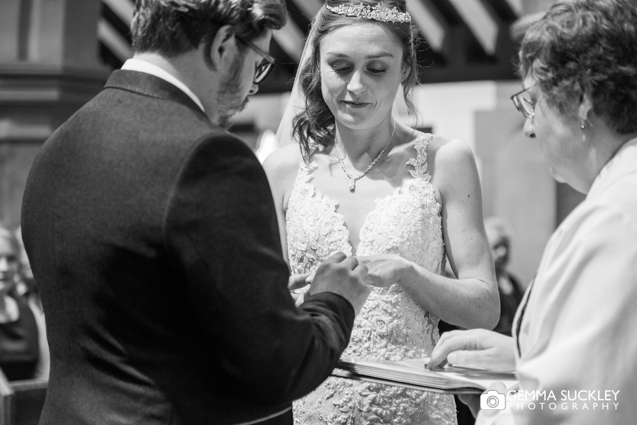 a groom places a ring on his brides finger