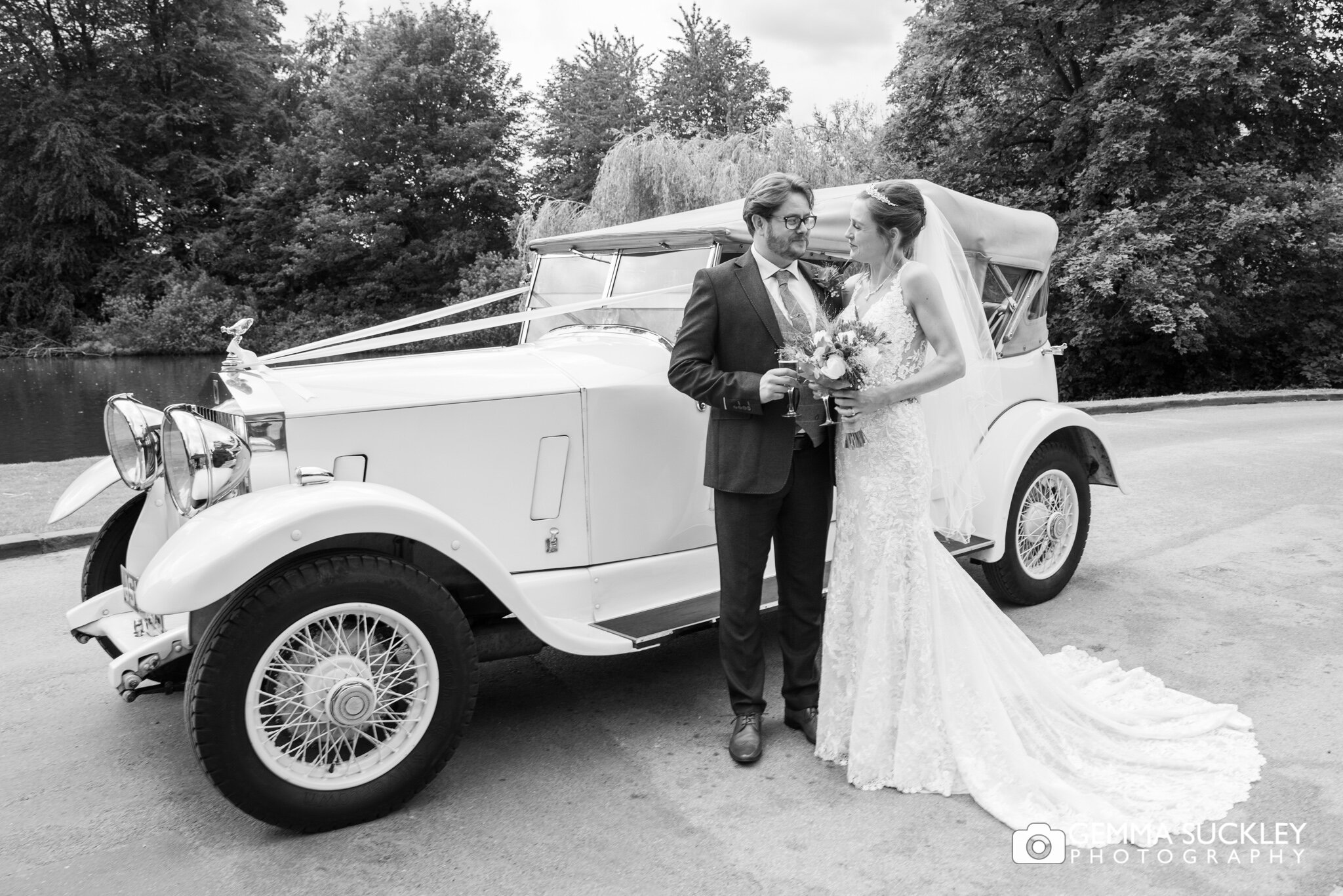 bride and groom arrive at east riddlesden hall in a vintage wedding car