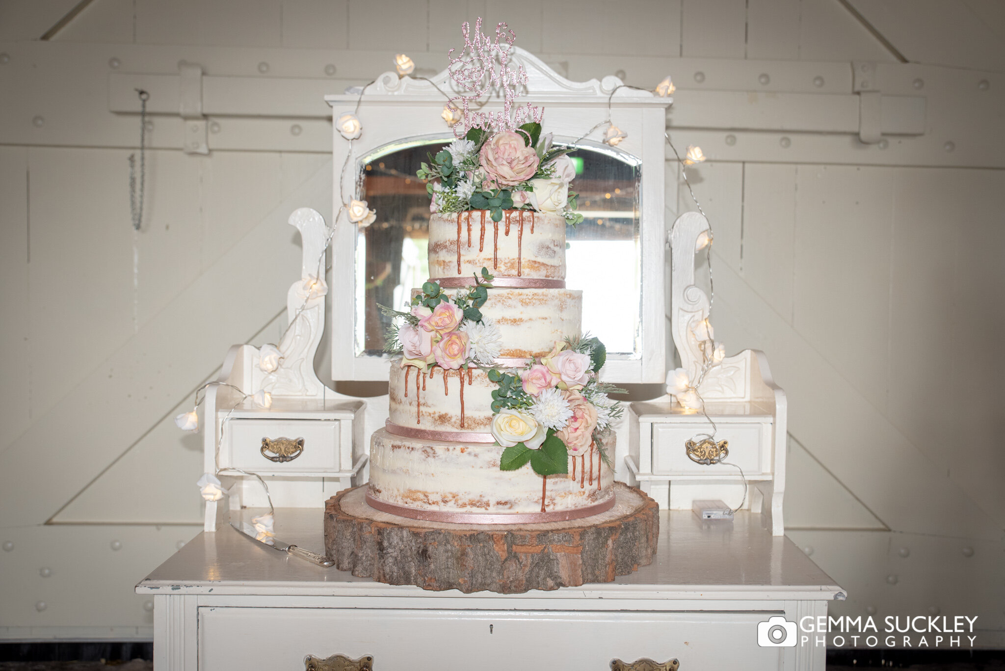 wedding cake on a white dresser at east riddlesden hall barn wedding