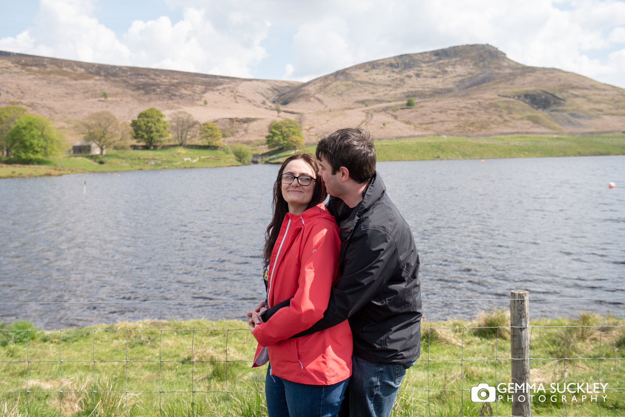 engaged couple hugging at embsay reservoir 